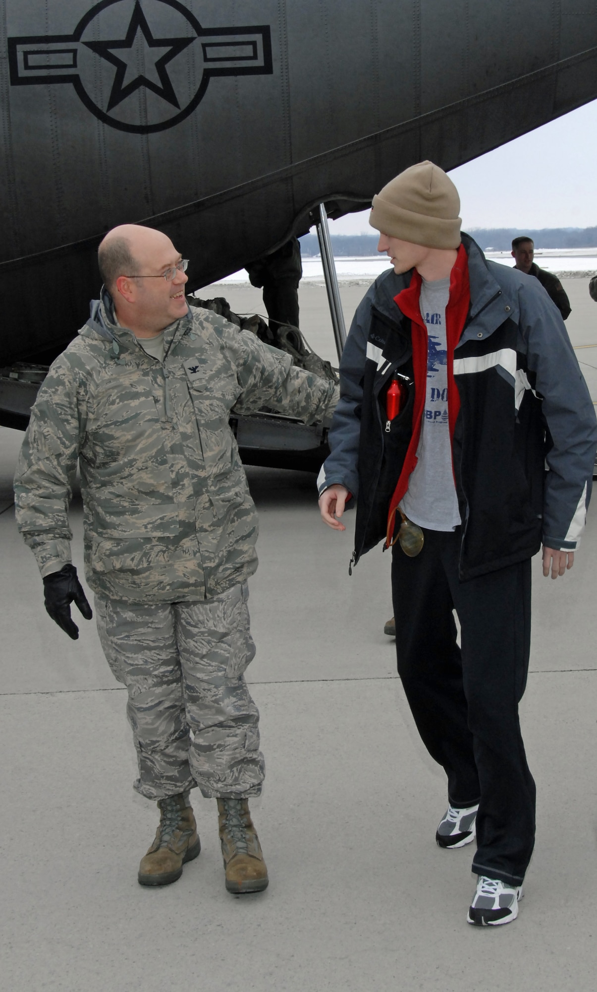 Col. Michael Stinson greets Senior Airman Tre Porfirio following Porfirio’s arrival Feb. 18, 2010 by a Kentucky Air National Guard C-130 aeromedical evacuation aircraft at Wright-Patterson Air Force Base, Ohio. Porfirio was shot three times in the back by an insurgent Nov. 21, 2009 while deployed with an Army unit in a remote part of Afghanistan.  He returned to Wright-Patt for a heroe’s welcome following a ground-breaking surgery and 3-month recovery at Walter Reed Army Medical Center.  Airman Porfirio is a communications technician with the 88th Communications Squadron. Col. Stinson is 88th Communications Group commander. (U.S. Air Force photo/Ben Strasser)
