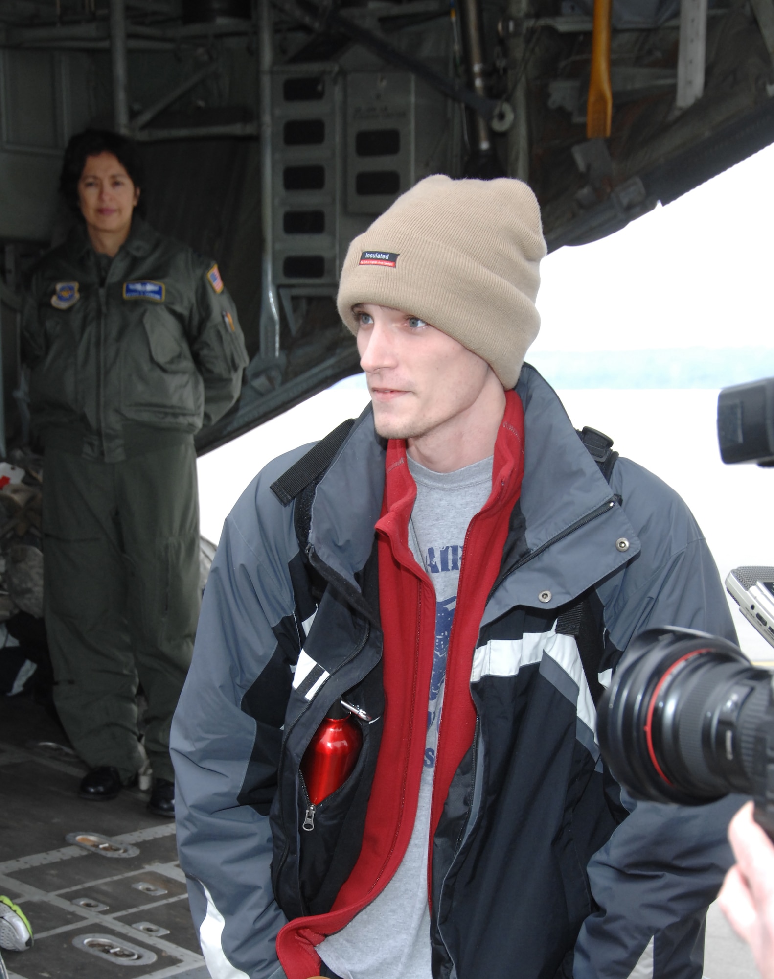Senior Airman Tre Porfirio exits a Kentucky Air National Guard C-130 aeromedical evacuation aircraft Feb. 18, 2010 at Wright-Patterson Air Force Base, Ohio.  Porfirio was shot three times in the back by an insurgent Nov. 21, 2009 while deployed with an Army unit in a remote part of Afghanistan.  He underwent a ground-breaking Thanksgiving Day surgery when doctors removed his damaged pancreas, harvested insulin-producing islet cells and infused them into his liver.  He returned to Wright-Patt for a heroe’s welcome following a 3-month recovery at Walter Reed Army Medical Center.  Airman Porfirio is a communications technician with the 88th Communications Squadron. (U.S. Air Force photo/Ben Strasser)

