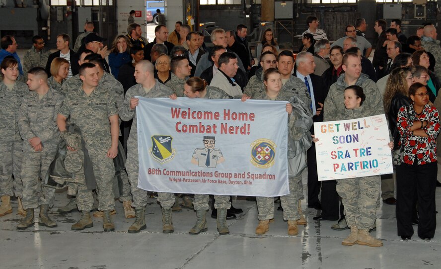 Members of the 88th Communications Group await the return of Senior Airman Tre Porfirio Feb. 18, 2010 at Wright-Patterson Air Force Base, Ohio.  About 300 of the “Combat Nerds” and other friends and community members greeted Porfirio during a welcome home ceremony. Porfirio was shot three times in the back by an insurgent Nov. 21, 2009 while deployed with an Army unit in a remote part of Afghanistan.  He returned to a heroe’s welcome at Wright-Patt following a 3-month recovery at Walter Reed Army Medical Center.  Airman Porfirio is a communications technician with the 88th Communications Squadron. (U.S. Air Force photo/Ben Strasser)
