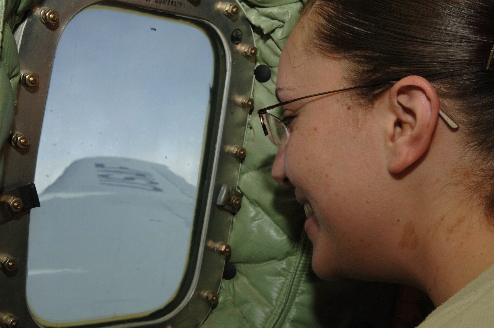 Airman 1st Class Elizabeth M. Corpus, 319th Operations Group, looks out the window of a KC-135 Stratotanker during an incentive flight Feb. 24. Incentive flights give Airmen an opportunity to see the 319th Air Refueling Wing’s primary mission first-hand. During this particular flight, Airmen witnessed boom operators refuel a B-52 Stratofortress. (U.S. Air Force photo by Senior Airman R. Michael Longoria)