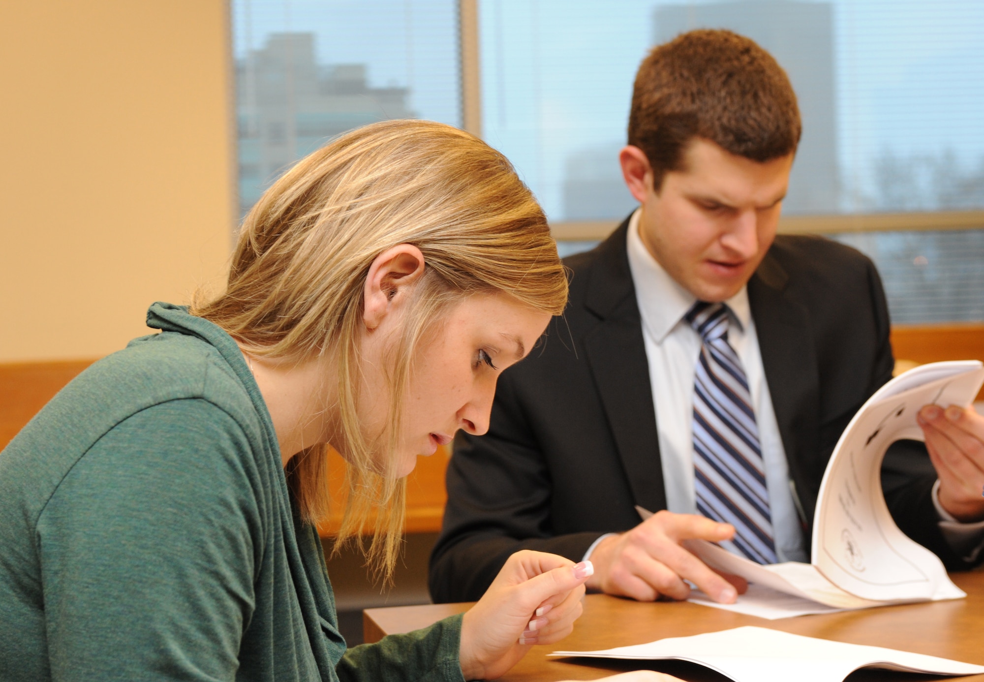 MOUNTAIN HOME AIR FORCE BASE, Idaho – Capt. William Hett, 366th Fighter Wing Judge Advocate General Office legal assistance chief, and Staff Sgt. Lindsey Riggs, 366th FW/JAG case paralegal, review their notes in preparation for a mock trial at the Ada County Courthouse in Boise Feb. 15. The JAG Office volunteered as judges in mock trials to educate eighth and ninth grade students on how the legal system functions. (U.S. Air Force photo by 1st Lt. Neil Samson)

