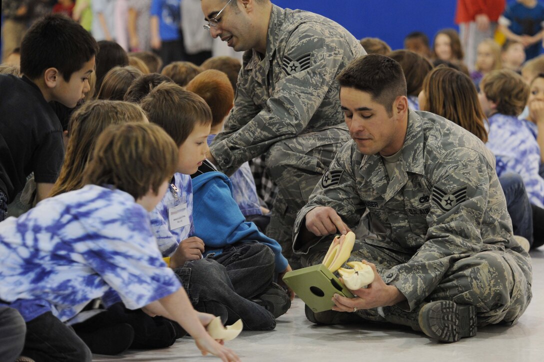 (Front) Staff Sgt. Jeff Hauser, 28th Medical Operations Group dental logistics NCO-in-charge, and Staff Sgt. Keith Duron, 28th Medical Operations Group preventive dentistry NCO-in-charge, educate children on the basics of teeth, at Francis Case School, Box Elder, S.D., Feb. 17. Both sergeants assisted Capt. Bradley Harrelson, 28th Medical Operations Squadron dentist, also known as Dr. Juggles, in his routine to encourage children to adopt proper dental care. (U.S. Air Force photo/Airman 1st Class Corey Hook)