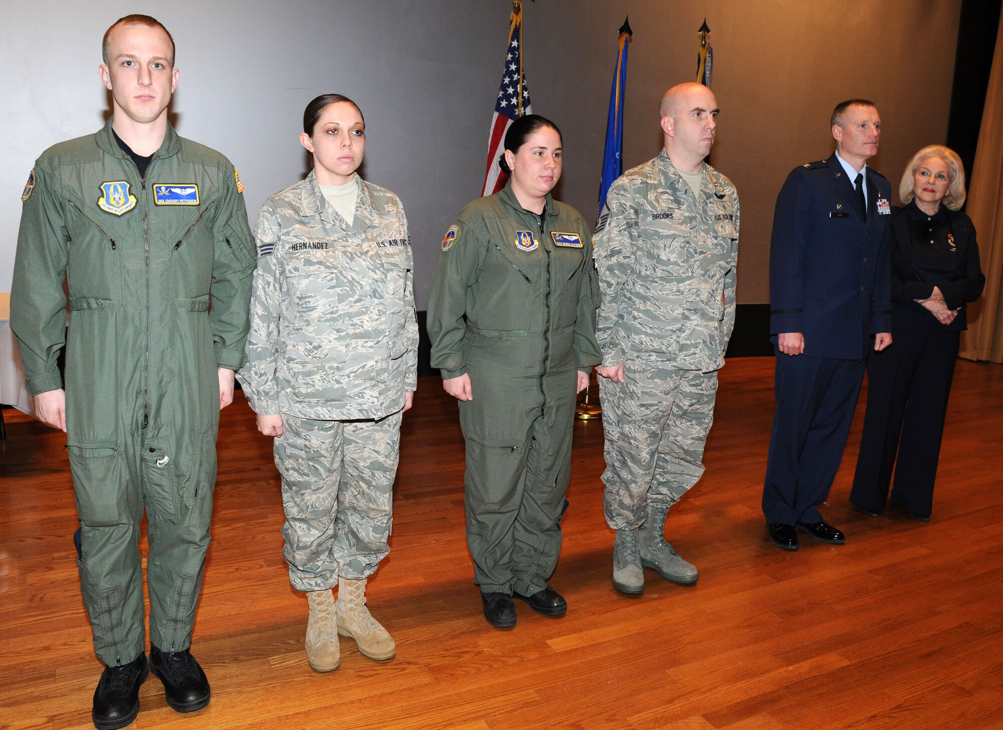 Senior Airman Zachary Pettigrew,Senior Airman Tiffiany Hernandez, Tech. Sgt Monica Eastman and Master Sgt. Mark Brooks, receive a commander's coin at the 927th Air Refueling Wing quarterly commander's call for their medical assistance in an automobile accident.  (U.S. Air Force photo/Tech. Sgt. Denise Hauser)