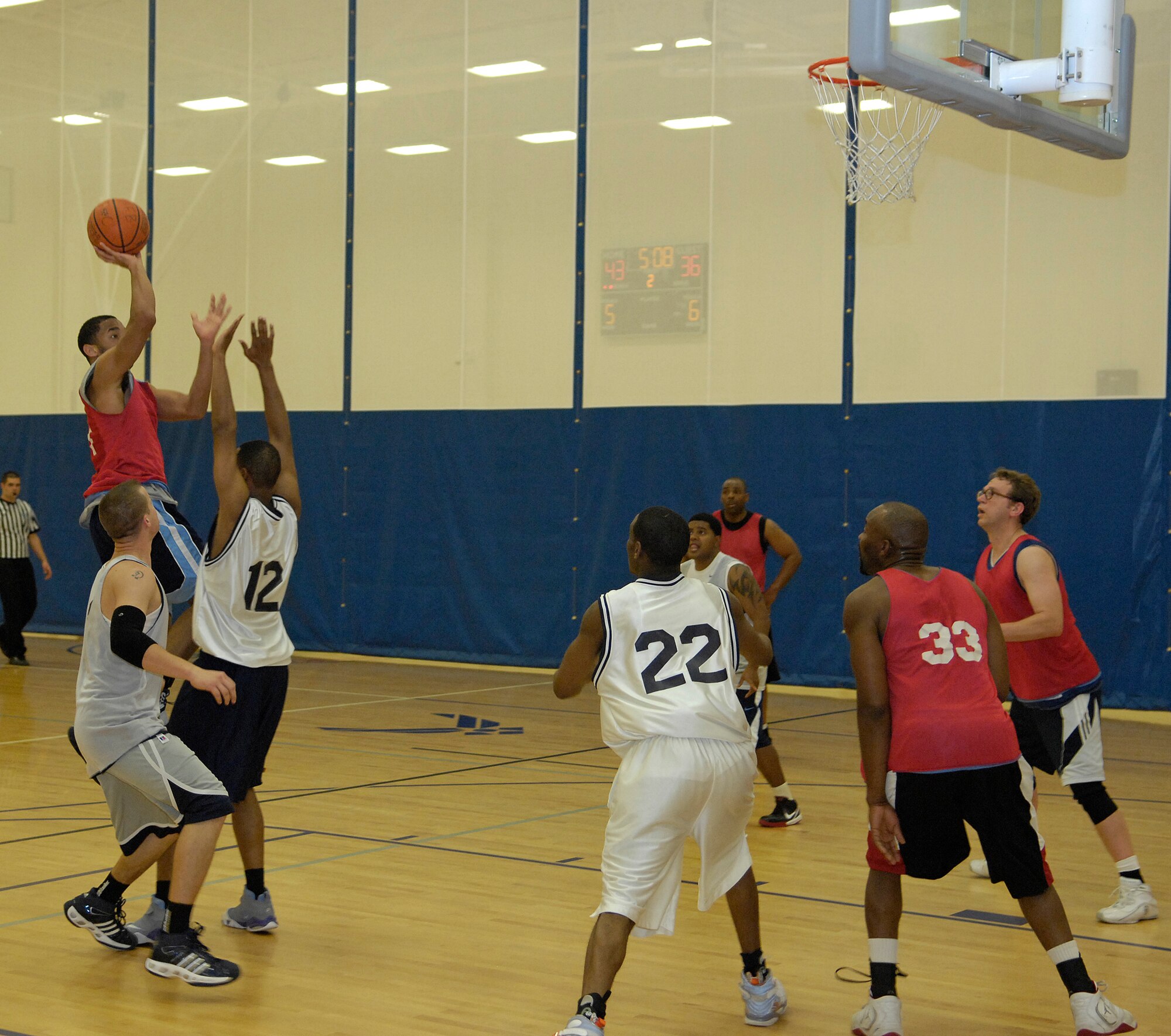 VANDENBERG AIR FORCE BASE, Calif. -- Lloyd Conley Jr., from the Old Guys team, attempts to shoot over the opposing players during an intramural basketball game here Tuesday, Feb. 23, 2010. The 30th Security Forces Squadron team took down the Old Guys team, winning 53-38. (U.S. Air Force photo/Airman 1st Class Andrew Lee) 

 

 
 