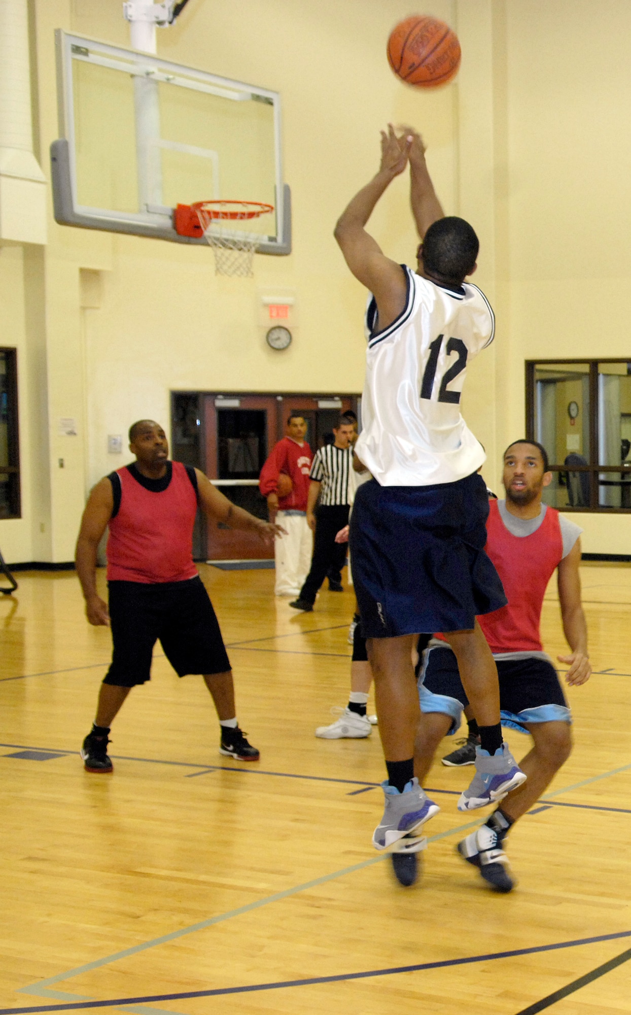 VANDENBERG AIR FORCE BASE, Calif. -- Onterrio Agnew, from the 30th Security Forces Squadron team, attempts to shoot a three-pointer over an opponent during an intramural basketball game here Tuesday, Feb. 23, 2010. The SFS team fought hard, winning 53-38 over the Old Guys team. (U.S. Air Force photo/Airman 1st Class Andrew Lee)

 