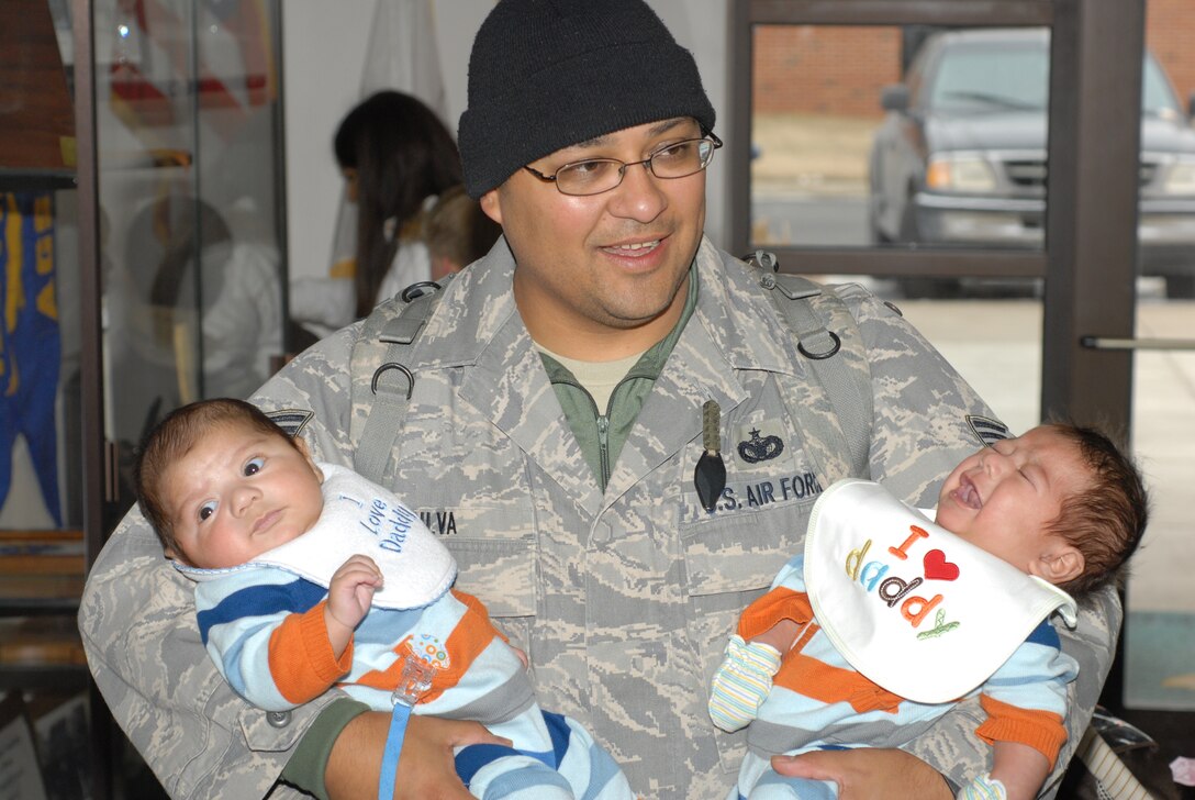 Tech Sgt. Salvador Silva, a member of the 126th Air Refueling Wing’s Security Forces Squadron Illinois Air National Guard, Scott Air Force Base, Ill., holds his newborn twins upon returning from a six month mobilization in support of Operation Iraqi Freedom. Silva held his newborn twins for the first time when he returned home Feb 12. (U.S. Air Force photo by Staff Sgt. Johnathon Orrell)