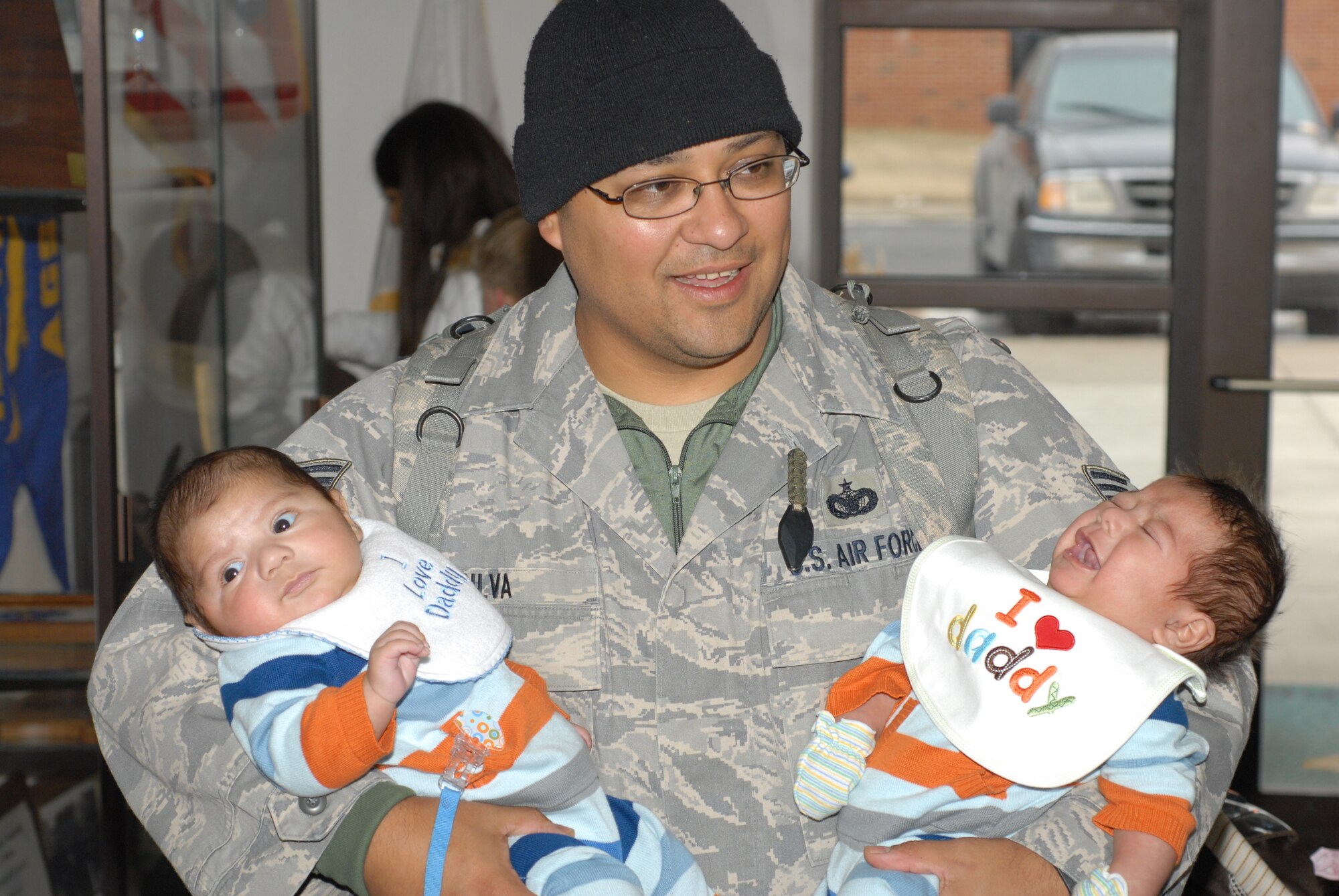 Tech Sgt. Salvador Silva, a member of the 126th Air Refueling Wing’s Security Forces Squadron Illinois Air National Guard, Scott Air Force Base, Ill., holds his newborn twins upon returning from a six month mobilization in support of Operation Iraqi Freedom. Silva held his newborn twins for the first time when he returned home Feb 12. (U.S. Air Force photo by Staff Sgt. Johnathon Orrell)