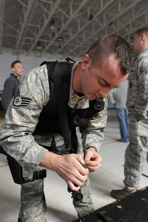 U.S. Air Force Staff Sgt. Brady Frazier loads an M-9 with simunitions prior to starting the Active Shooter Training Course at Mt. Pleasant, S.C., Feb. 23, 2010. The AST course prepares first responders on how to react to a hostile situation. Sergeant Frazier is a security forces member with the 628 Security Forces Squadron at Joint Base Charleston. (U.S. Air Force photo by James M. Bowman/released)