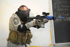 U.S. Air Force Chief MSgt. Tim Winfree opens fire on a perpetrator during a clearing room exercise while attending the Active Shooter Training Course in Mt. Pleasant, S.C., Feb. 23, 2010. The AST course prepares first responders on how to react to a hostile situation. Chief Winfree is the superintendent with the 50th Mission Support Group at Schriever AFB, Colo. (U.S. Air Force photo by James M. Bowman/released)