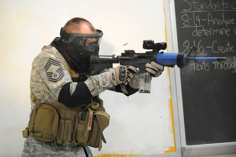 U.S. Air Force Chief MSgt. Tim Winfree opens fire on a perpetrator during a clearing room exercise while attending the Active Shooter Training Course in Mt. Pleasant, S.C., Feb. 23, 2010. The AST course prepares first responders on how to react to a hostile situation. Chief Winfree is the superintendent with the 50th Mission Support Group at Schriever AFB, Colo. (U.S. Air Force photo by James M. Bowman/released)

