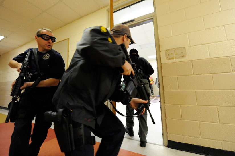 Dennis rushes into a room to clear the area during the Active Shooter Training Course at Mt. Pleasant, S.C., Feb. 23, 2010. The AST course prepares first responders on how to react to a hostile situation. Dennis is with the U.S. Marshals Service in Charleston, S.C. (U.S. Air Force photo by James M. Bowman/released)

