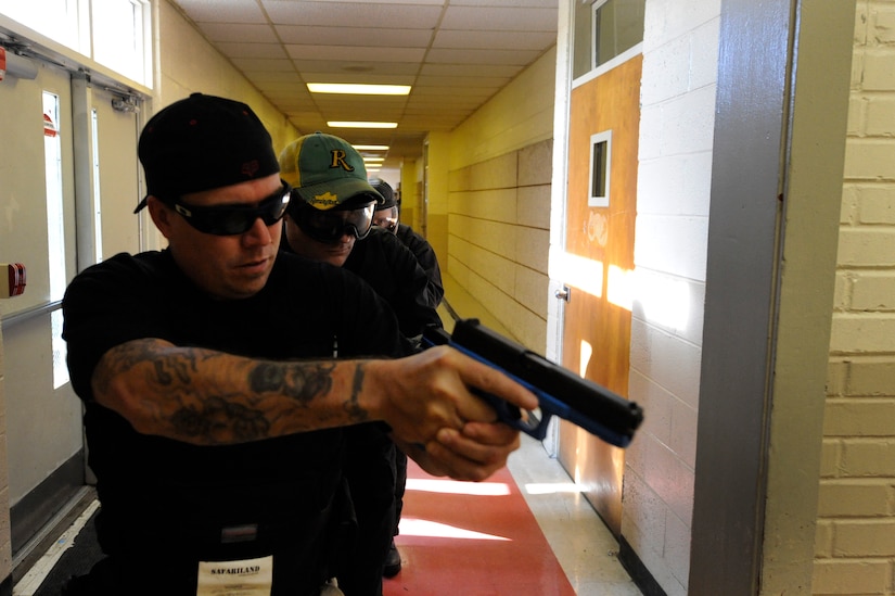 Patrolman Sean Fox and other members prepare to engage an aggressor during the Active Shooter Training Course at Mt. Pleasant, S.C., Feb. 23, 2010. The AST course prepares first responders on how to react to a hostile situation. Mr. Fox is with Charleston county aviation authority police department. (U.S. Air Force photo by James M. Bowman/released)


