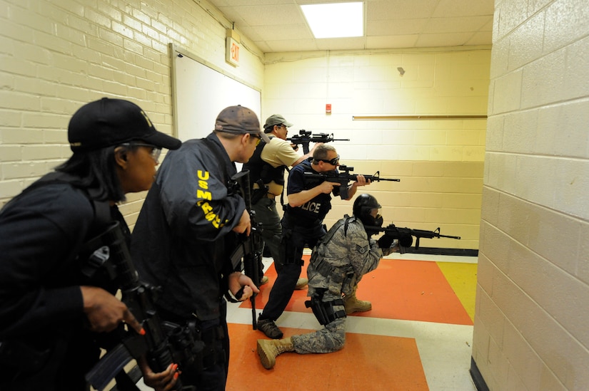 Law enforcement and Air Force security members prepare to engage an aggressor during Active Shooter Training Course at Mt. Pleasant, S.C., Feb. 23, 2010. The AST course prepares first responders on how to react to a hostile situation. (U.S. Air Force photo by James M. Bowman/released)



