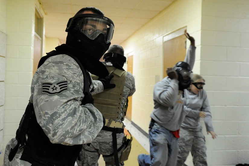 U.S. Air Force Staff Sgt. Brady Frazier provides rear cover during a hallway clearing scenario during the Active Shooter Training Course at Mt. Pleasant, S.C., Feb. 23, 2010. The AST course prepares first responders on how to react to a hostile situation. (U.S. Air Force photo by James M. Bowman/released)



