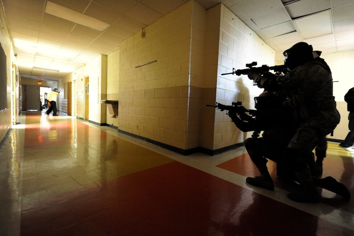 Security forces members prepare to shoot an aggressor during the Active Shooter Training Course at Mt. Pleasant, S.C., Feb. 23, 2010. The AST course prepares first responders on how to react to a hostile situation. (U.S. Air Force photo by James M. Bowman/released)