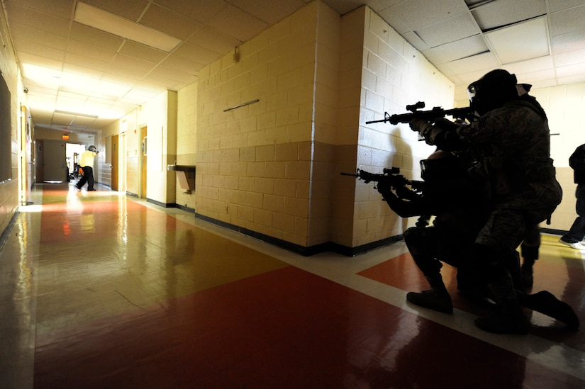 Security forces members prepare to shoot an aggressor during the Active Shooter Training Course at Mt. Pleasant, S.C., Feb. 23, 2010. The AST course prepares first responders on how to react to a hostile situation. (U.S. Air Force photo by James M. Bowman/released)


