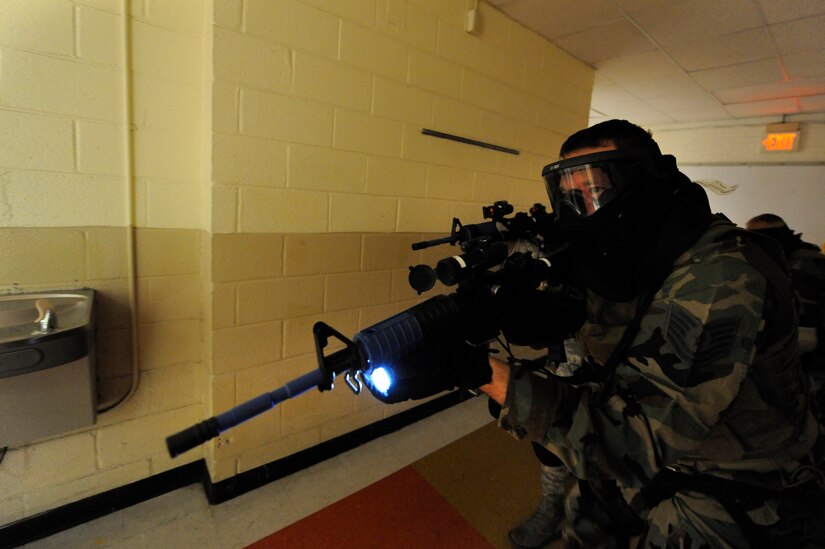 U.S. Air Force Tech. Sgt. Bradley Krause performs a hallway clearing during a mock hostile situation during the Active Shooter Training Course at Mt. Pleasant, S.C., Feb. 23, 2010. The AST course prepares first responders on how to react to a hostile situation. Sergeant Krause is with the 50th Security Forces Squadron and is the Non-commissioned officer in charge of training he is stationed at Schriever Air Force Base, Colo. (U.S. Air Force photo by James M. Bowman/released)

