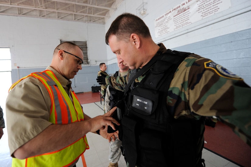 Nick Minzghor performs a safety search on Michael Brady prior to starting the  Active Shooter Training Course at Mt. Pleasant, S.C., Feb. 23, 2010. The AST course prepares first responders on how to react to a hostile situation.  Mr. Minzghor is the lead instructor of AST and Mr. Brady is the supervisory police officer with the 628th Security Forces Squadron at Joint base Charleston. (U.S. Air Force photo by James M. Bowman/released)
