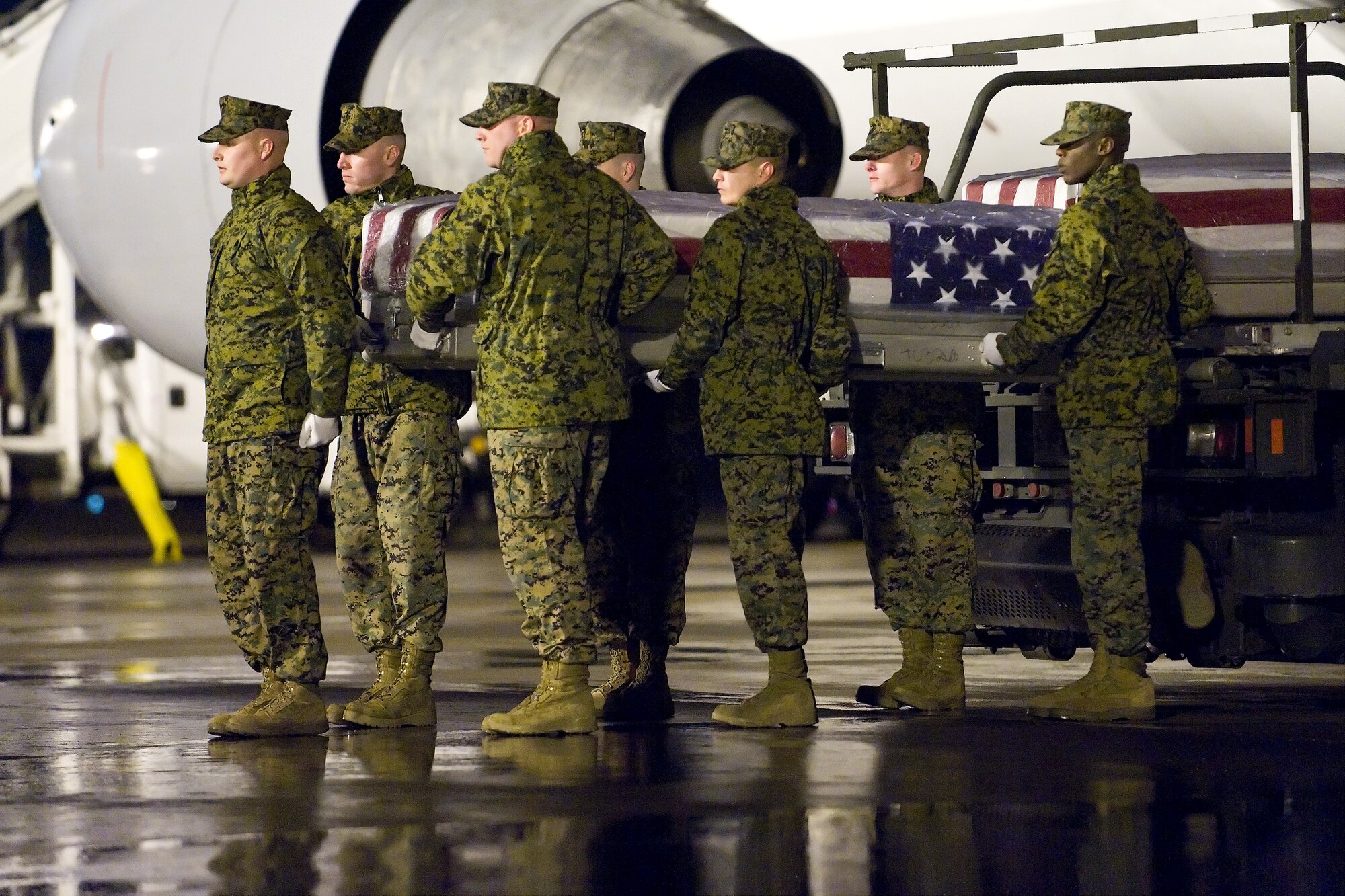 A U.S. Marine Corps team transfers the remains of Marine Corps Staff Sgt. Christopher W. Eckard, of Hickory, N.C., at Dover Air Force Base, Del., February 23. Staff Sgt. Eckard was assigned to 8th Engineer Support Battalion, 2nd Marine Logistics Group, II Marine Expeditionary Force, Camp Lejeune, N.C. (U.S. Air Force photo/Roland Balik)