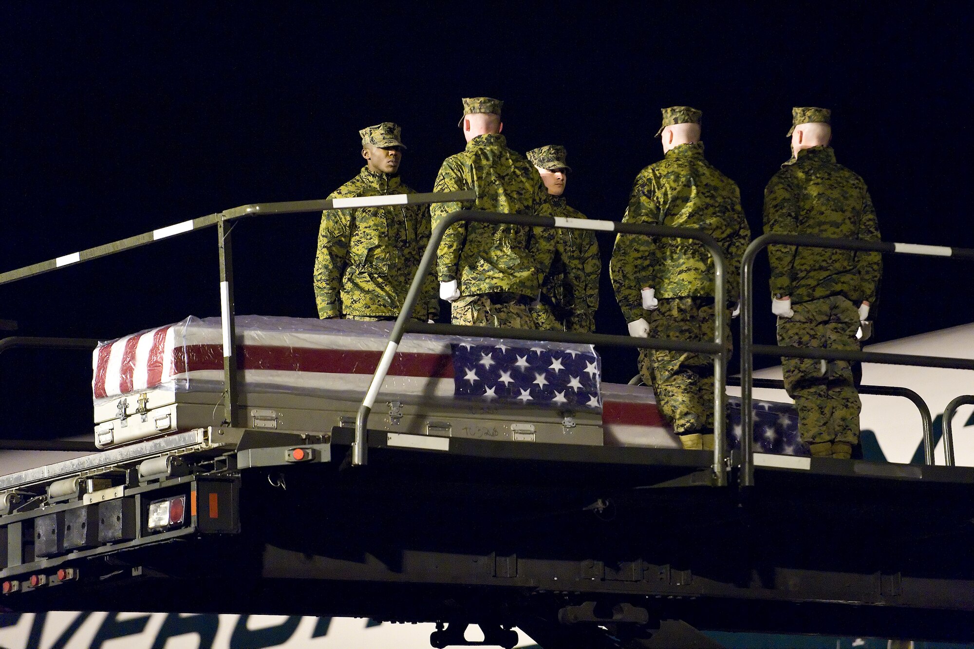A U.S. Marine Corps team transfers the remains of Marine Corps Lance Cpl. Adam D. Peak, of Florence, Ky., at Dover Air Force Base, Del., February 23. Lance Cpl. Peak was assigned to 2nd Battalion, 2nd Marine Regiment, 2nd Marine Division, II Marine Expeditionary Force, Camp Lejeune, N.C. (U.S. Air Force photo/Roland Balik)