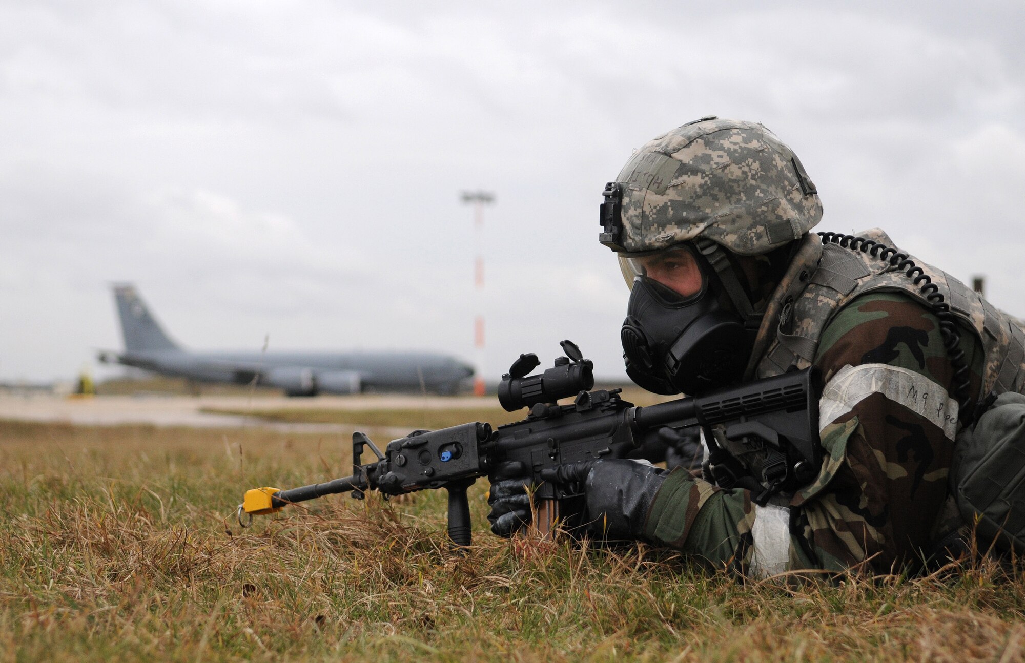 RAF MILDENHALL, England -- Senior Airman Mitchell Nichols, 100th Security Forces Squadron, watches for opposing forces after a simulated ground attack at Base X here Feb. 25. Airman Nichols was manning an entry control point to the operational readiness exercise area when explosions were heard, red smoke appeared and chemical weapon use warnings came over the radio. (U.S. Air Force photo/Senior Airman Thomas Trower) 