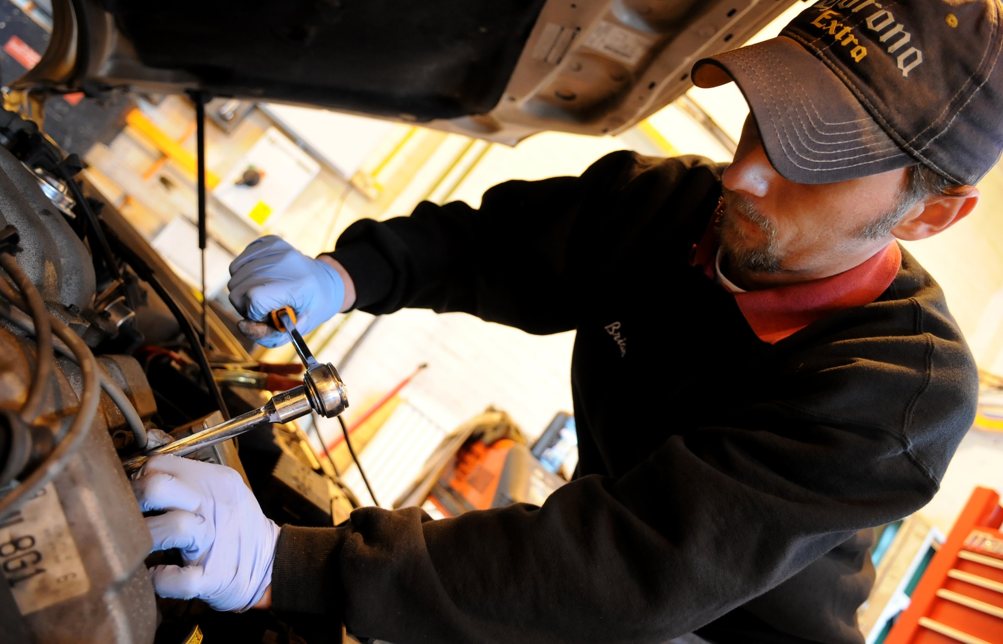 RAF MILDENHALL, England – Brian Muse, volunteer mechanic, removes a spark plug while performing an engine tune up at the Auto Hobby Shop Feb. 24. (U.S. Air Force photo/ Staff Sgt. Jerry Fleshman)