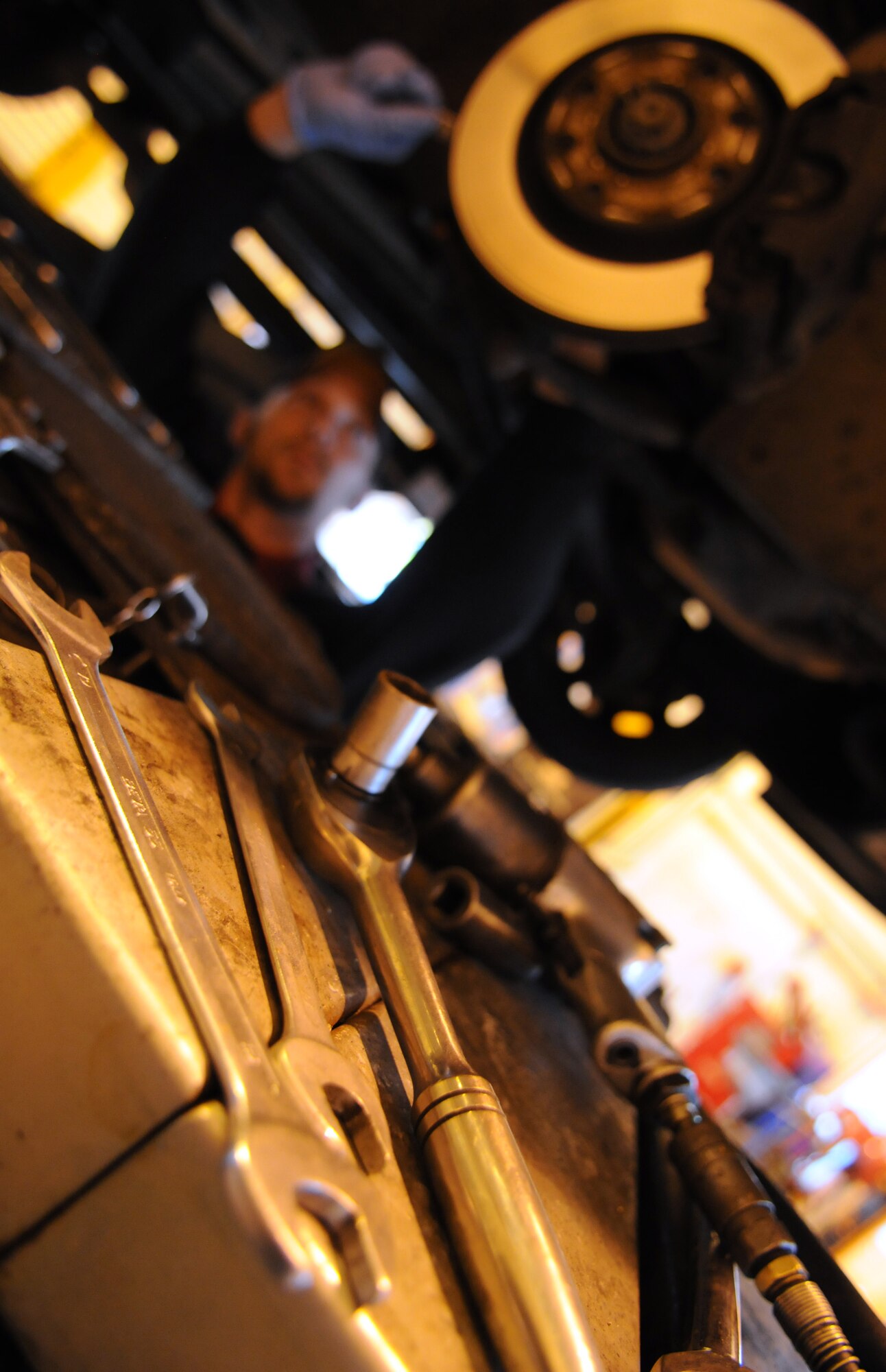 RAF MILDENHALL, England – Tools lay out on a lift while Brian Muse, volunteer mechanic, performs a brake change at the Auto Hobby Shop Feb. 24. The hobby shop provides a wide variety of services for RAF Mildenhall Airmen. Hours of operations are Monday through Friday, 8 a.m. to 8 p.m., Saturday, 9 a.m. to 5 p.m. and Sunday noon, to 6 p.m. For more details on services provided, availability and pricing contact the Auto Hobby Shop call DSN 238-2480. (U.S. Air Force photo/ Staff Sgt. Jerry Fleshman)