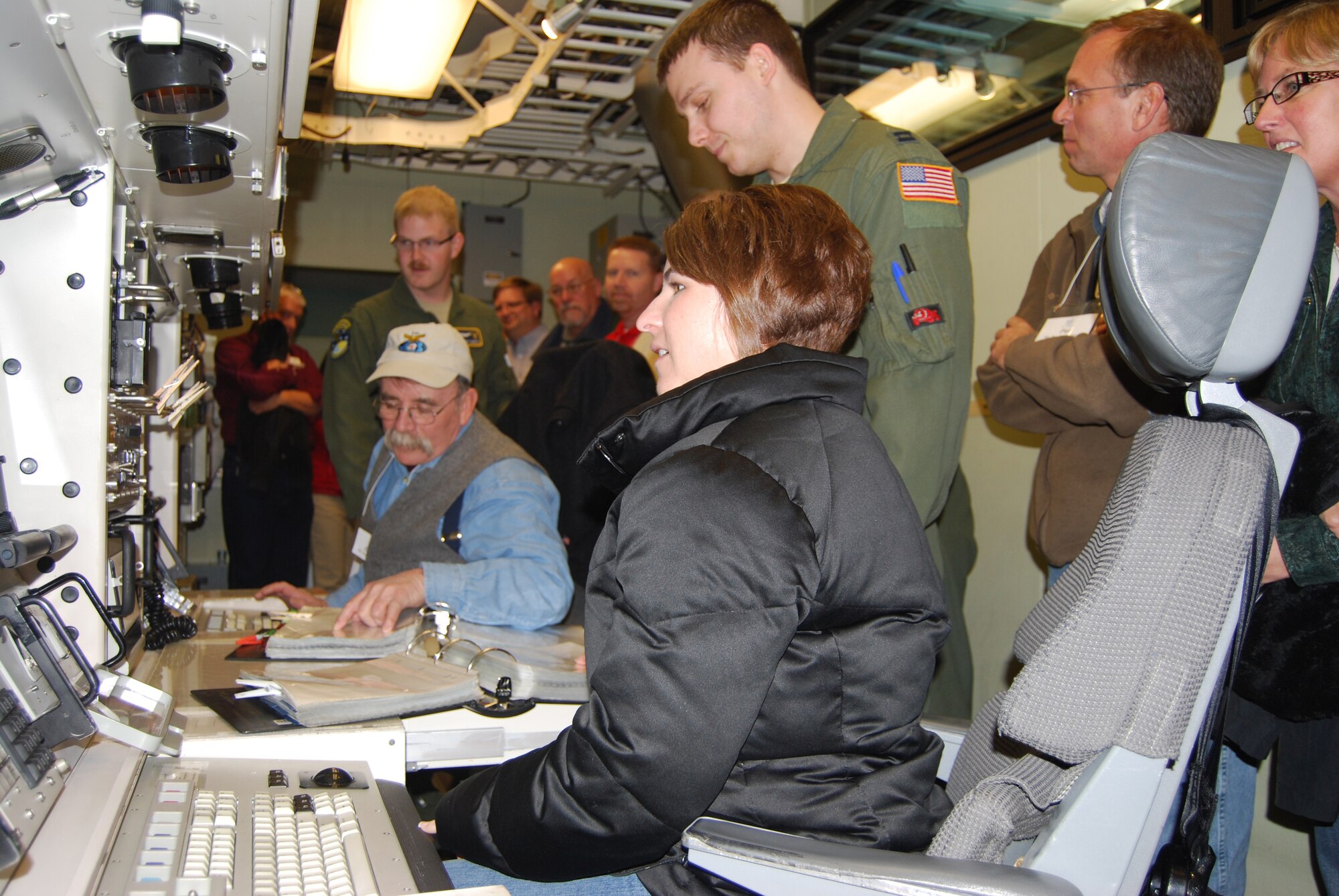 Shauna Albrechi, member of Leadership Montana, gets a closer look at a missile launch simulator from Capt. Nicholas Somerman, 341st Operations Support Squadron ICBM combat crew instructor, during a tour of Malmstrom  Feb. 18.(U.S. Air Force photo/2nd Lt. Marshel Slater)