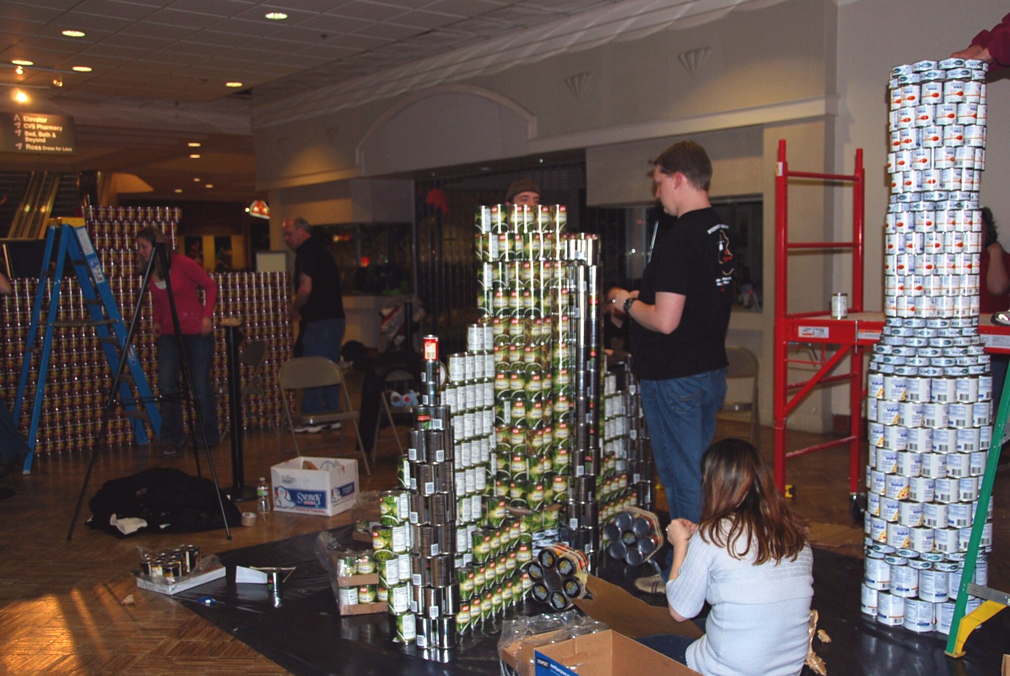 Members of the Great Falls Association of Realtors stack cans to build their replica of an F-15 Fighter during the CANstruction project at the Holiday Village Mall Feb. 19. (Courtesy photo)