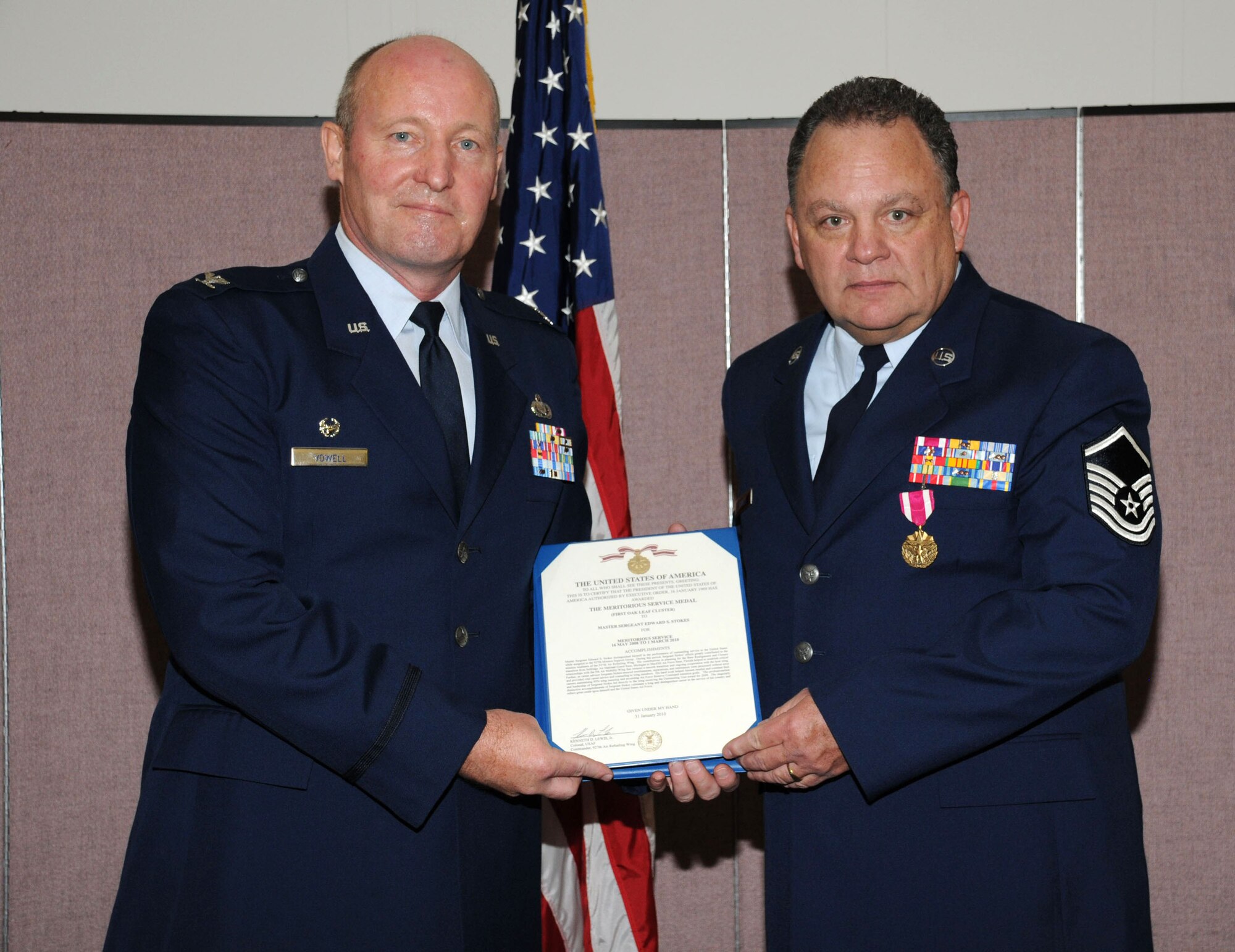 Col. Vowell, 927th Mission Support Group Commander, presents Master Sgt. Edward Stokes with a Meritorious Service Medal at Stokes' retirement ceremony Feb 20.  Stokes retired from the Air Force Reserve after 33 years of service.  (U.S. Air Force photo/Tech. Sgt. Denise Hauser)