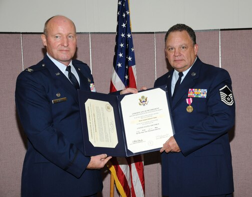 Col. Vowell, 927th Mission Support Group Commander, presents Master Sgt. Edward Stokes with his retirement certificate at a ceremony Feb 20.  Stokes retired from the Air Force Reserve after 33 years of service.  (U.S. Air Force photo/Tech. Sgt. Denise Hauser)