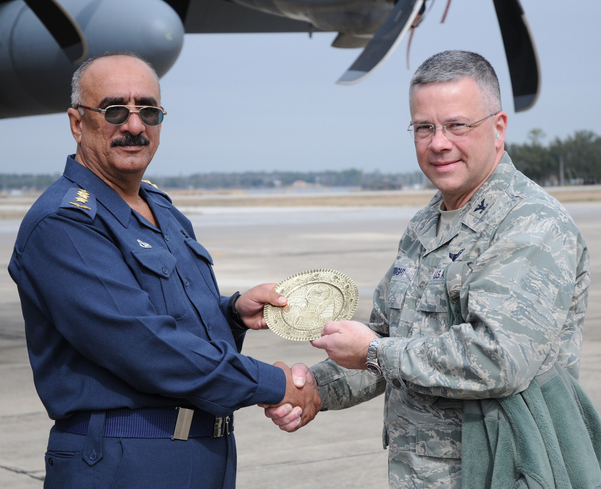 During the 512th Airlift Wing Civic Leader Tour Feb. 18-19 to Dobbins Air Reserve Base, Ga., and Keesler AFB, Miss, Col. Randal L. Bright, 512th AW commander (right) receives a token of goodwill from Colonel Salman, Iraqi air force meteorological department director and senior meteorologist. Colonel Salman was at Keesler AFB observing the 53rd Weather Reconnasance Squadron as part of a four-base observation tour of units with weather missions for use in the meteorology department in Iraq. (U.S. Air Force photo/Capt. Marnee A.C. Losurdo) 