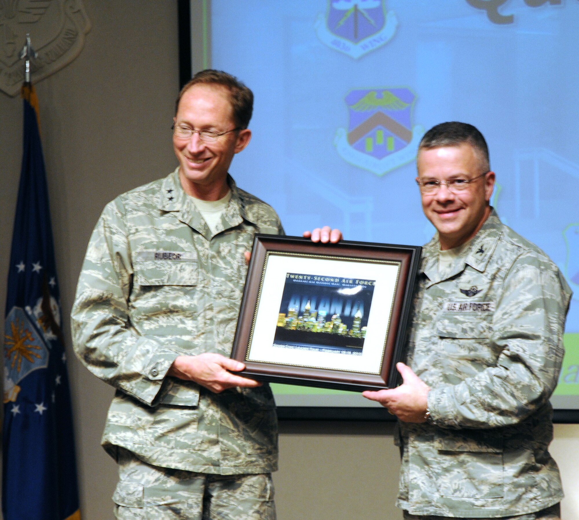 Maj. Gen. James T. Rubeor, 22nd Air Force commander, presents Col. Randal L. Bright, 512th Airlift Wing commander, with a souvenir graphic from Atlanta Feb. 18. Col. Bright and 19 civic leaders from Dover and the surrounding areas participated in a two-day civic leader tour to Dobbins Air Reserve Base, Ga., and Keesler Air Force Base, Miss. General Rubeor briefed the guests on the Air Force Reserve and how Dover Air Force Base contributes to the overall mission. (U.S. Air Force photo/Capt. Marnee A.C. Losurdo) 