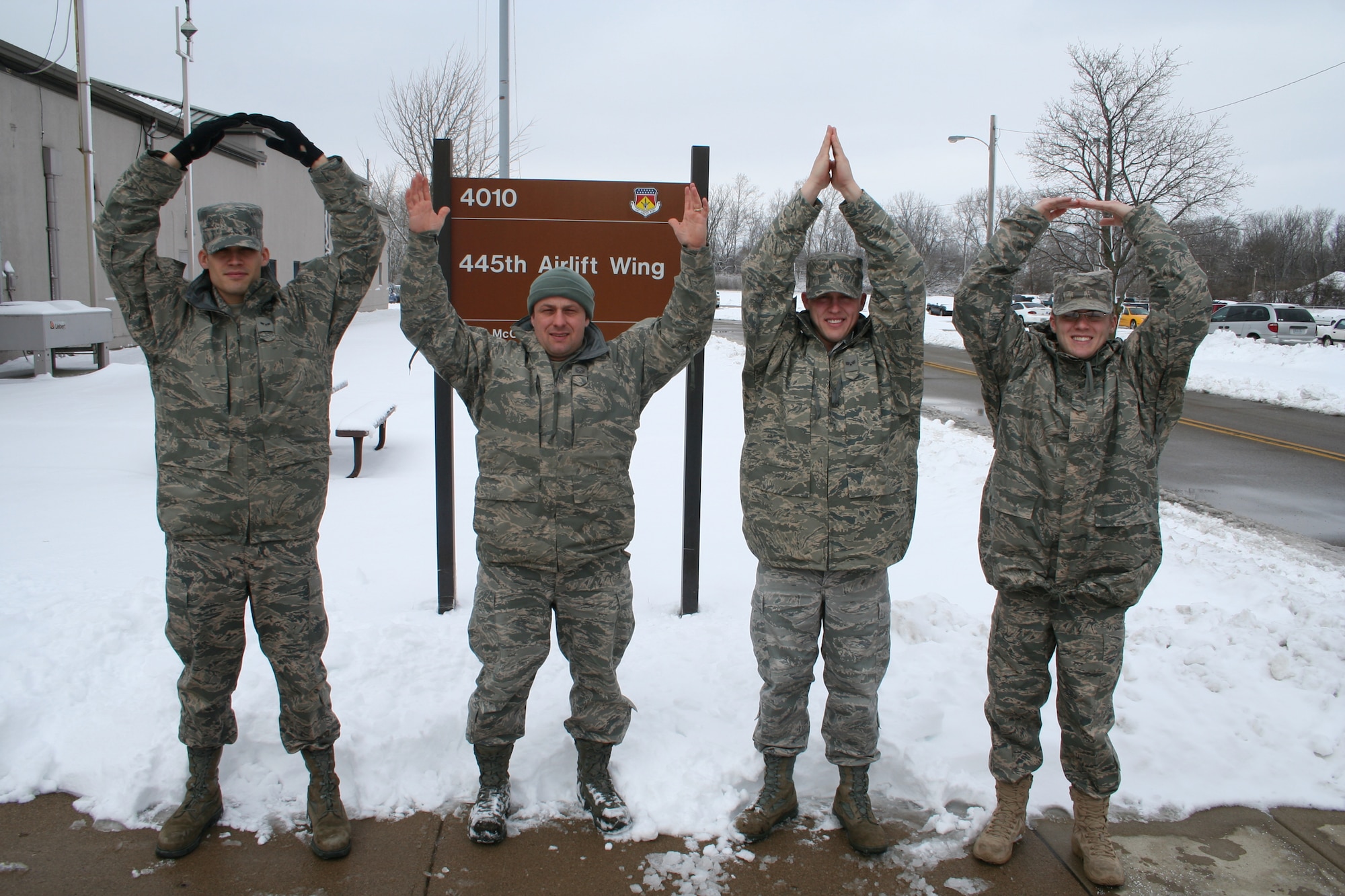 WRIGHT-PATTERSON AIR FORCE BASE, Ohio -  The family of Airmen assigned to the 445th Airlift Wing spell out Ohio in front of the wing's headquarters building. Pictured from left to right: Airman First Class Gabriel Page, Master Sgt. Bob McDonald, and Senior Airmen Matthew Cook and Matthew McDonald.(U.S. Air Force photo/Tech. Sgt. Jeremy Caskey)