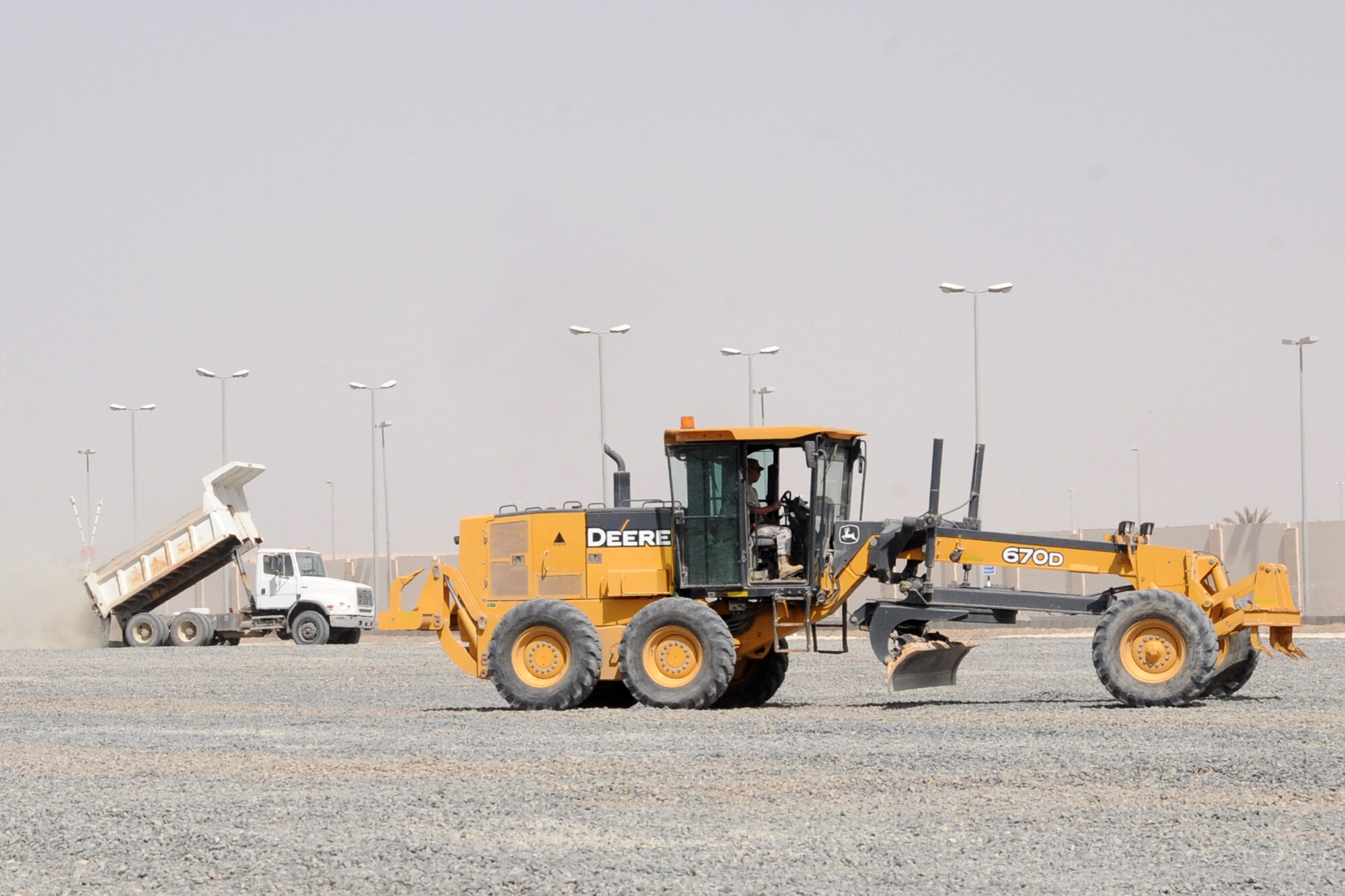Members of the 380th Expeditionary Civil Engineer Squadron perform maintenance on a parking lot at an undisclosed location in Southwest Asia Feb. 24, 2010. (U.S. Air Force Photo/Senior Airman Jenifer H. Calhoun/Released)

