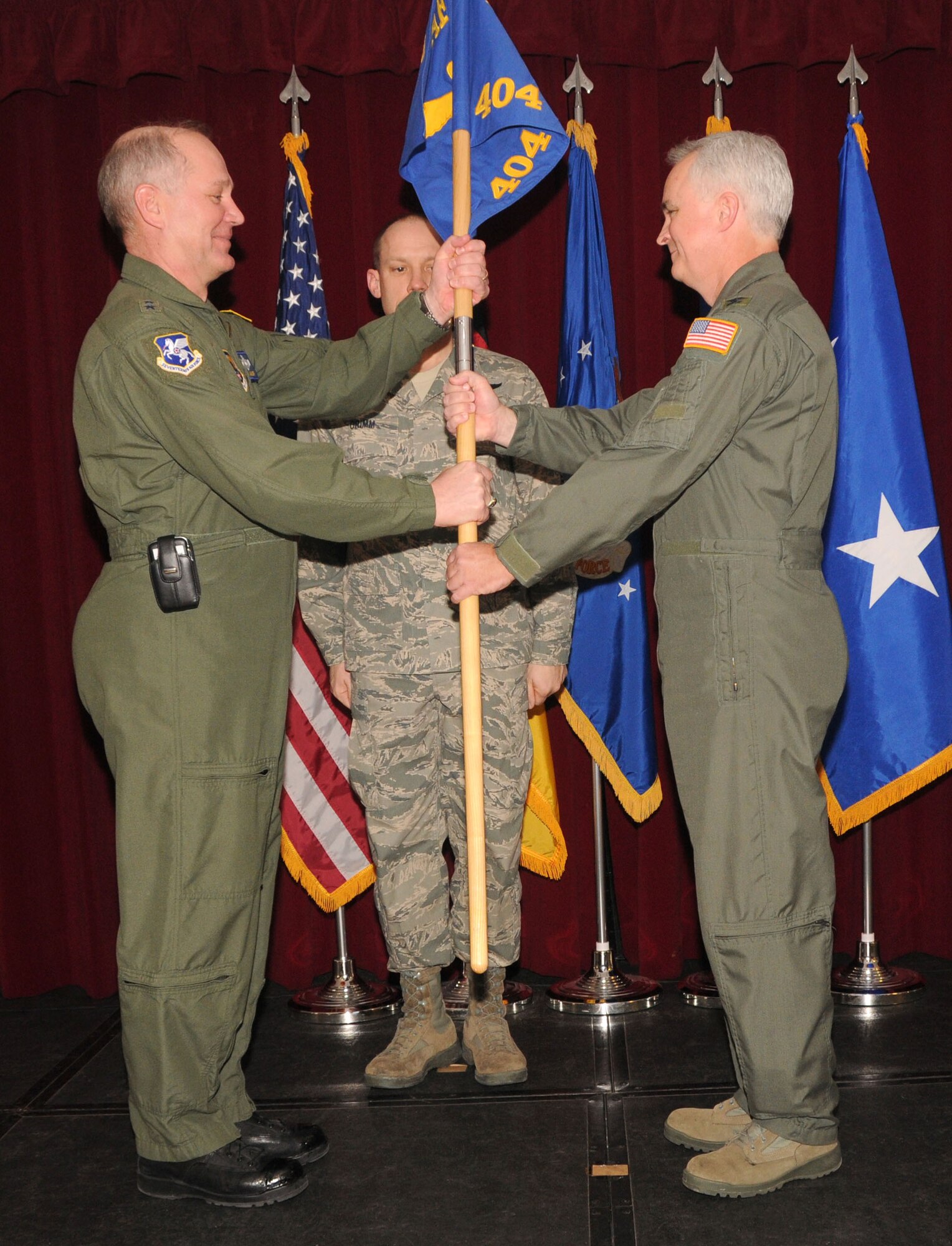 Maj. Gen. Ronald Ladnier, 17th Air Force (Air Forces Africa) commander, hands the guidon to the new commander of the 404th Air Expeditionary Group, Col. Phillip Fallin, during a change of command ceremony Feb. 25 at the Ramstein Community Center. Colonel Fallin takes command from Col. Jeffrey MacDonald, who led the group from September 2009. The 404th AEG provides intratheater airlift support for U.S. Africa Command taskings. (U.S. Air Force photo by Staff Sgt. Stefanie Torres)