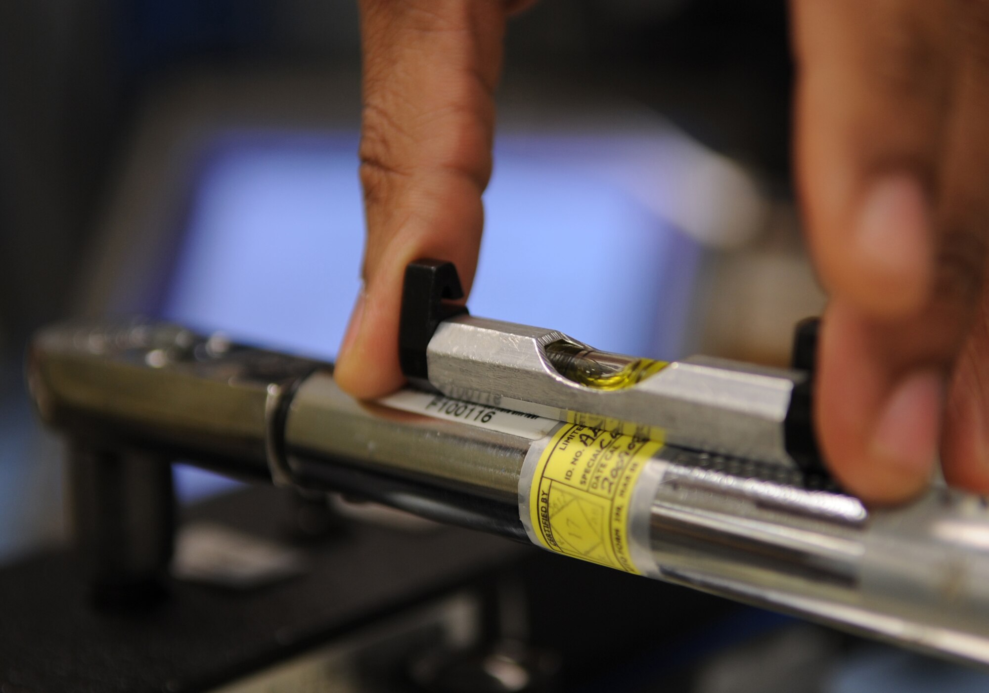 U.S. Air Force Airman 1st Class Dante Butler, 86th Maintenance Squadron Test Measurement and Diagnostic flight technician, checks the level of a torque wrench prior to calibration, Ramstein Air Base, Germany, Feb. 23, 2010.  The flight consists of a Scheduling Section, Shipping/Receiving section, Admin Section and the Precision Measurement Equipment Laboratory (PMEL) and services customers throughout United States Air Forces in Europe, United States Central Command, and United States Africa Command. (U.S. Air Force photo by Airman 1st Class Caleb Pierce)