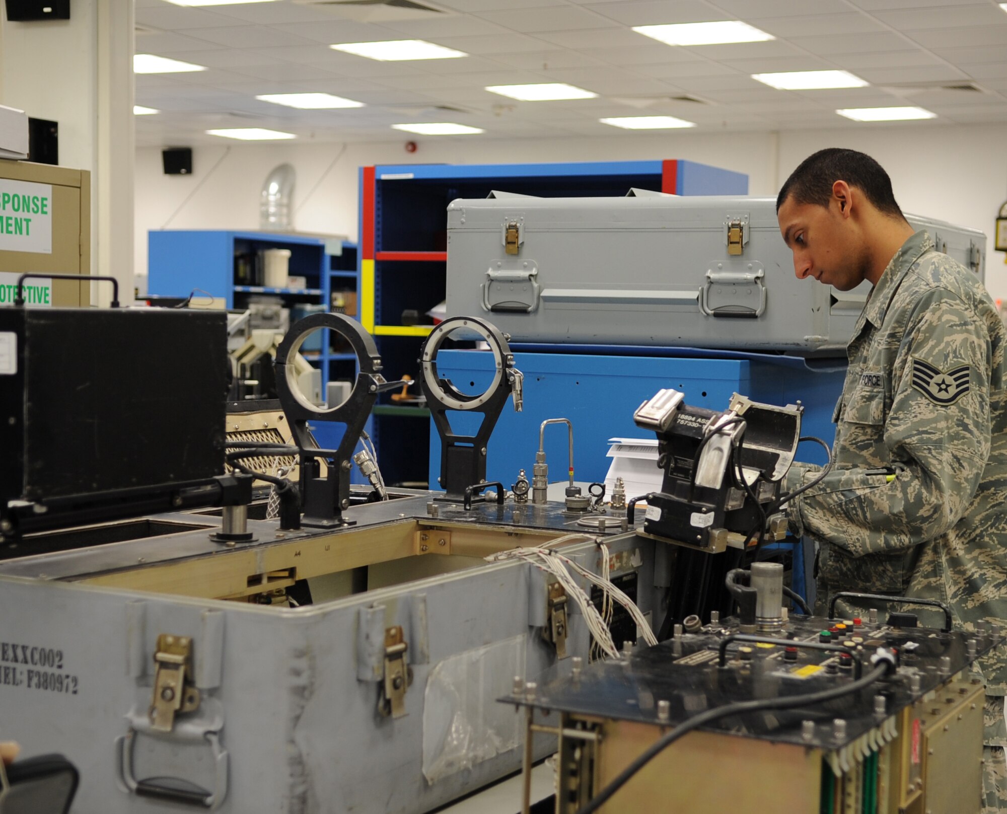 U.S. Air Force Staff Sgt. Edward Nassy, 86th Maintenance Squadron Test Measurement and Diagnostic flight technician, reads over a manual for a guided missile tester, Ramstein Air Base, Germany, Feb. 23, 2010.  The flight consists of a Scheduling Section, Shipping/Receiving section, Admin Section and the Precision Measurement Equipment Laboratory (PMEL) and services customers throughout United States Air Forces in Europe, United States Central Command, and United States Africa Command. (U.S. Air Force photo by Airman 1st Class Caleb Pierce)