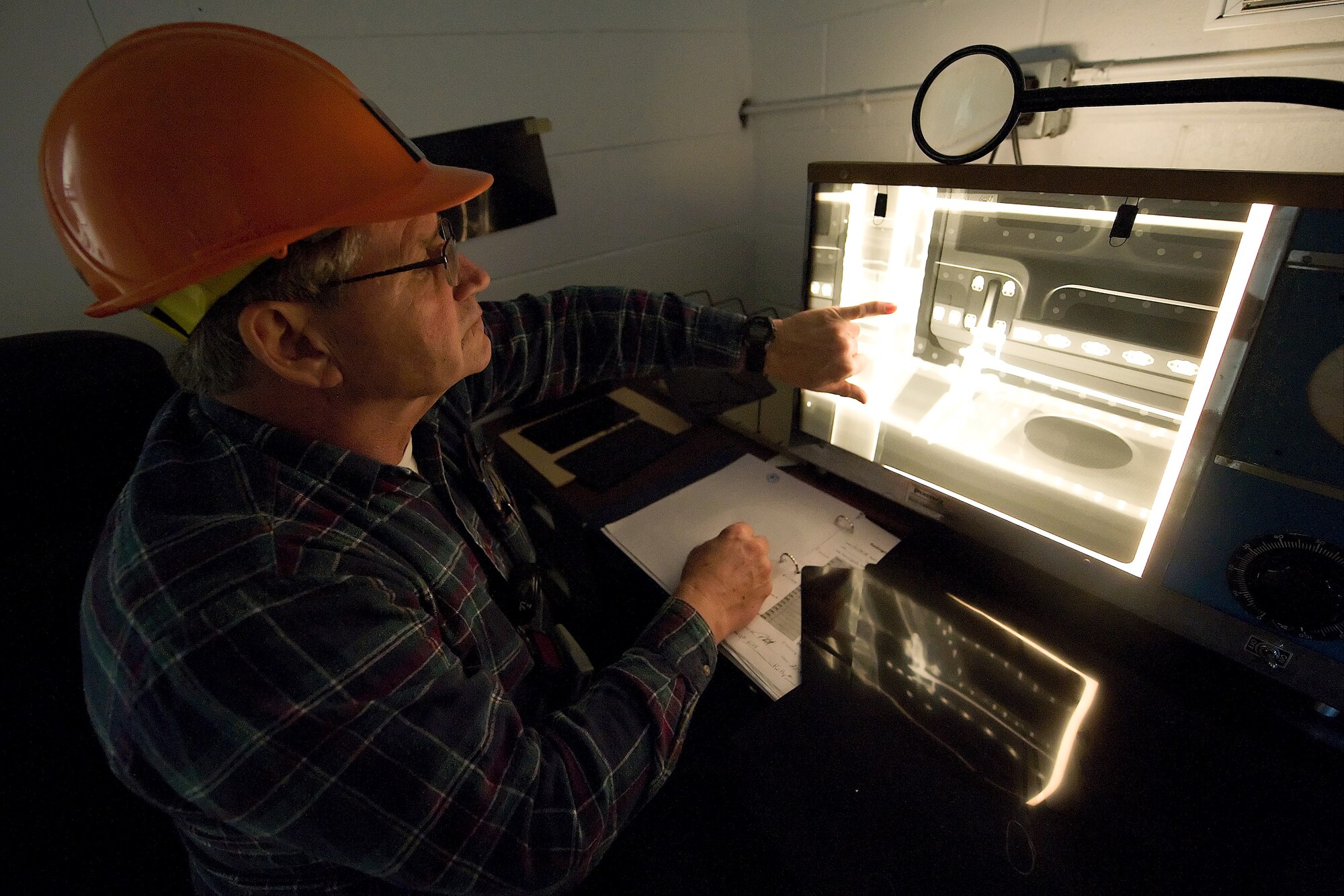 James Thompson, 436th Maintenance Squadron fabrication flight non-destructive inspection technician, points at an x-ray photo that has been taken of a section of a C-5 Galaxy Turbo Fan-39 engine inlet. The 436th MSX has been taking x-rays of engine inlets to ensure there are no foreign objects stuck inside the inlet. The foreign objects can cause damamge to the engine, but by locating and removing them, 436th MXS is saving the Air Force money and man hours. (U.S. Air Force photo/Brianne Zimny)
