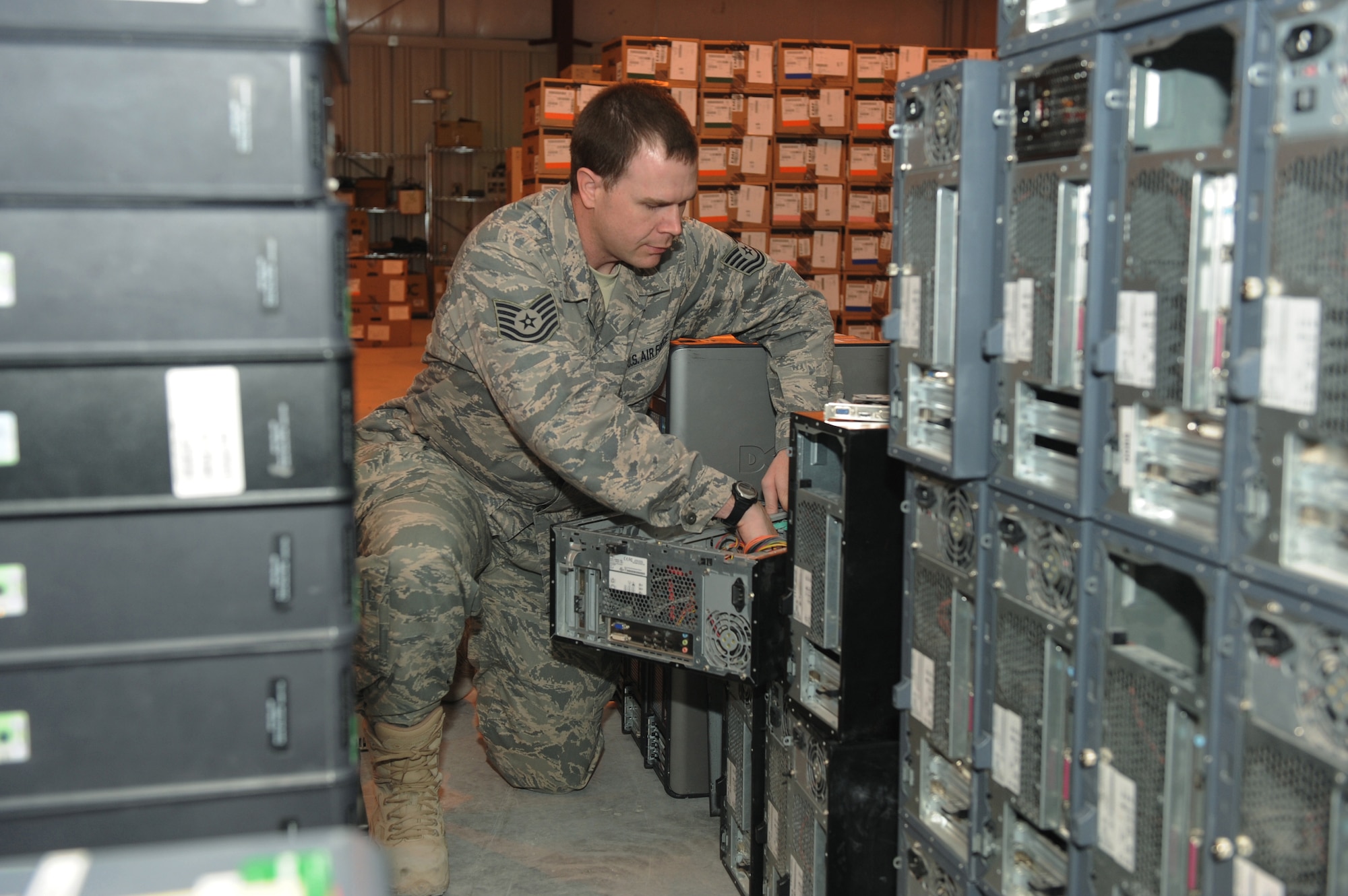Tech. Sgt. Josh Doolittle, 379th Expeditionary Communications Squadron base equipment control officer, salvages broken computer equipment received during an amnesty turn-in day at a non-disclosed Southwest Asia location, Feb 19, 2010. (U.S. Air Force photo by Tech. Sgt. Michelle Larche)[RELEASED]