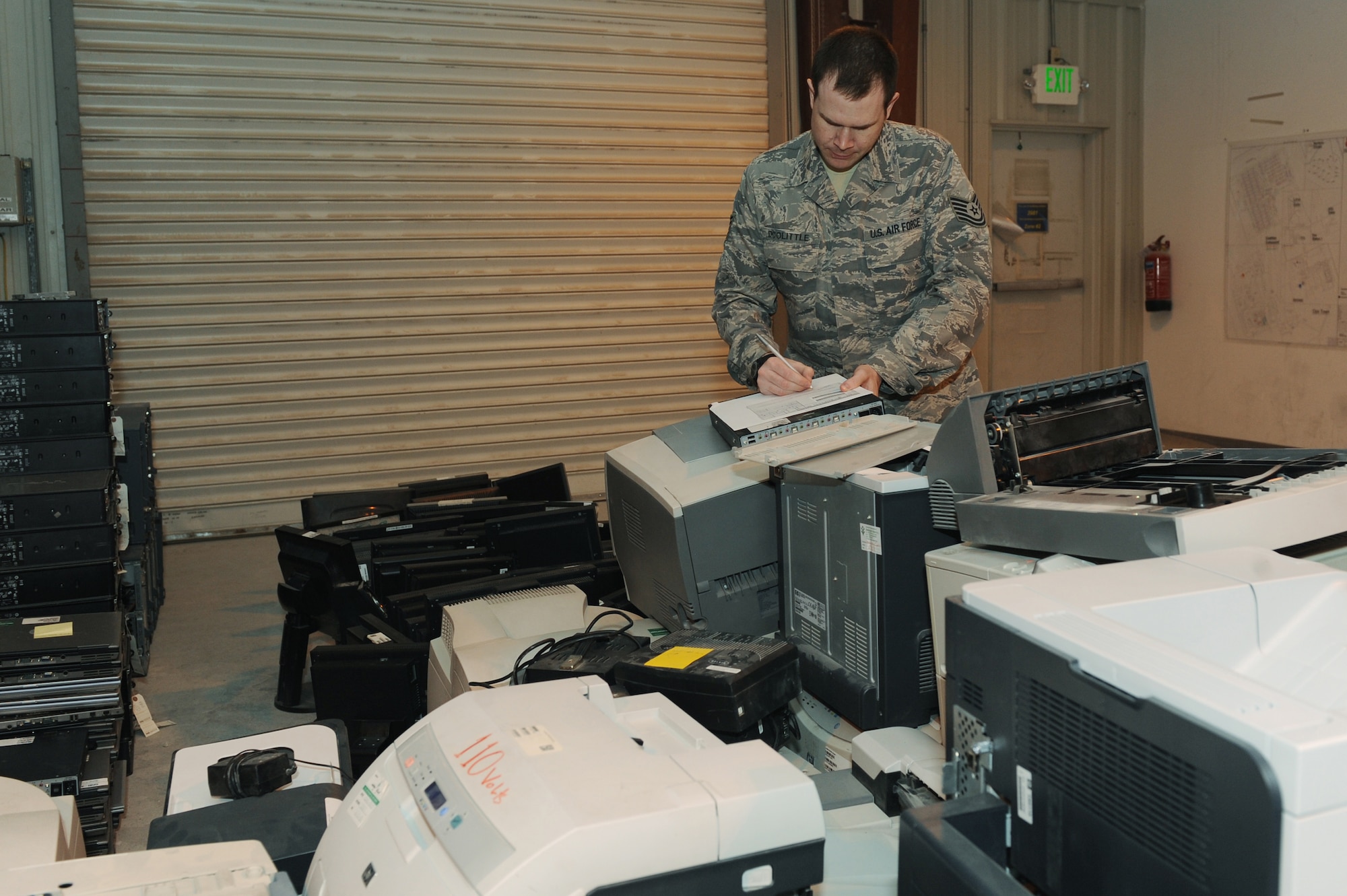 Tech. Sgt. Josh Doolittle, 379th Expeditionary Communications Squadron base equipment control officer, completes transfer paperwork on computer items received during an amnesty turn-in day at a non-disclosed Southwest Asia location, Feb 19, 2010. (U.S. Air Force photo by Tech. Sgt. Michelle Larche)[RELEASED]