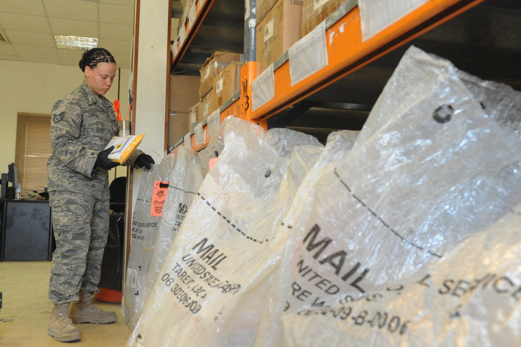 Staff Sgt. Amaris Carter, 379th Expeditionary Communications Squadron postal receiving and dispatch technician, sorts through out-going mail at a non-disclosed Southwest Asia location, Jan. 24, 2010. (U.S. Air Force photo by Tech. Sgt. Michelle Larche)[RELEASED]