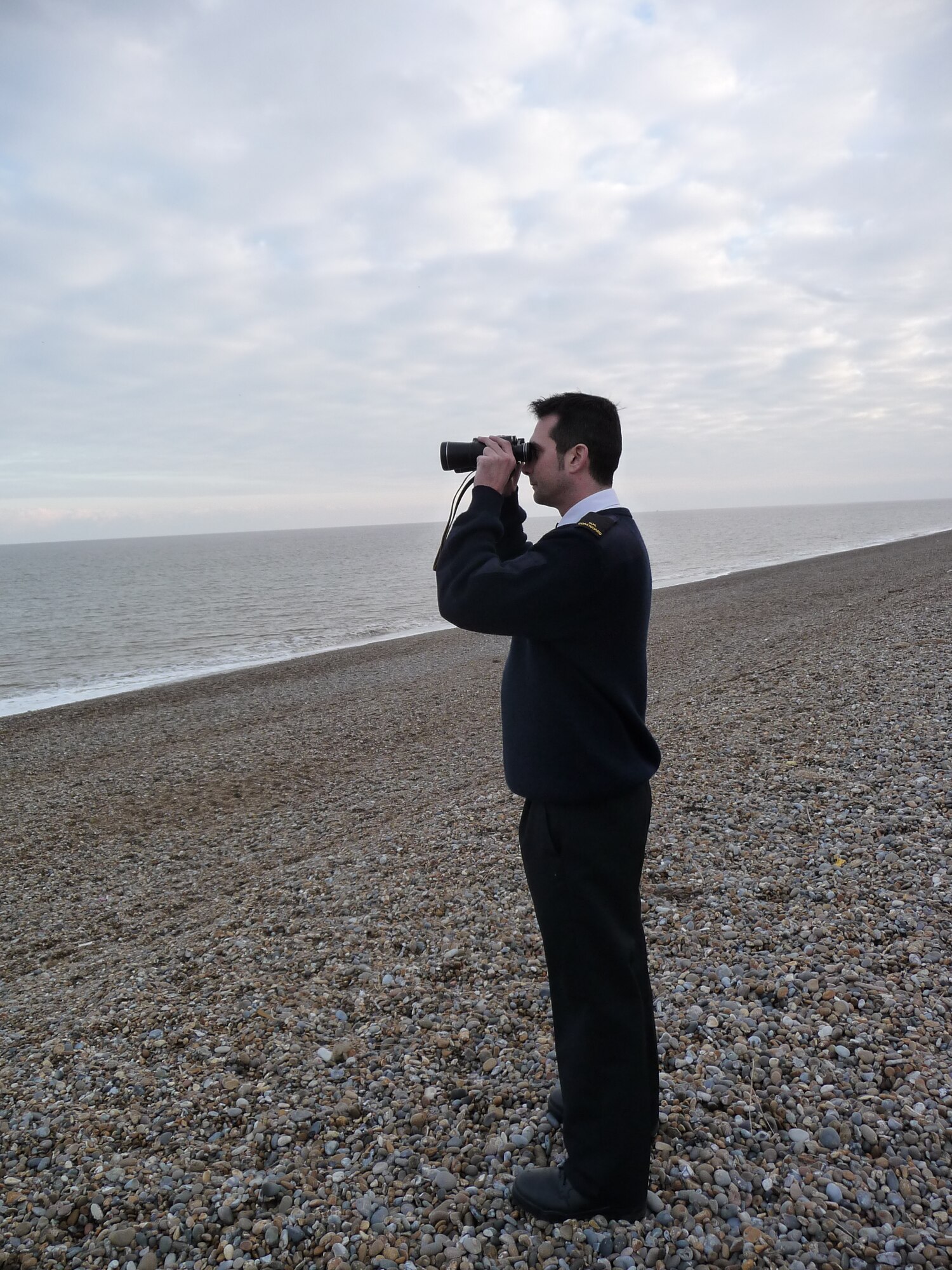 Andrew Norman, 48th Component Maintenance Squadron dedicated engine supply support technician and Her Majesty’s Coast Guard search and rescue officer, keeps a look out for shipping or distress signals at Aldeburgh Beach, Suffolk Feb. 15.(U.S. Air Force/courtesy photo)

