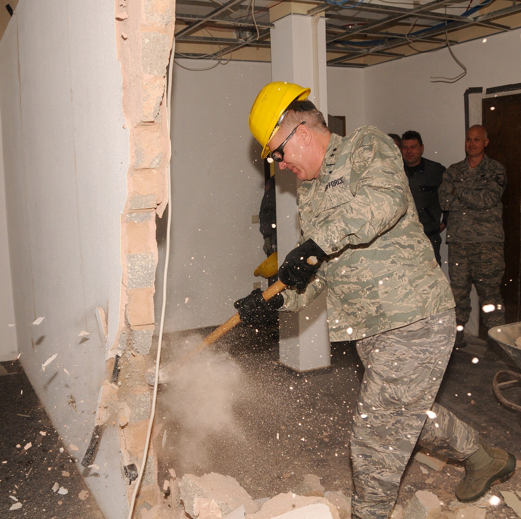 Maj. Gen. Ronald Ladnier, 17th Air Force (Air Forces Africa) commander, uses a sledge hammer to tear down one of the walls in the 17th AF Headquarters building Feb. 25. A renovation process of the building began in October of 2008 and is scheduled to be completed by June 2010 with more than $6 million worth of facility and communications upgrades. (U.S. Air Force photo by Staff Sgt. Stefanie Torres)