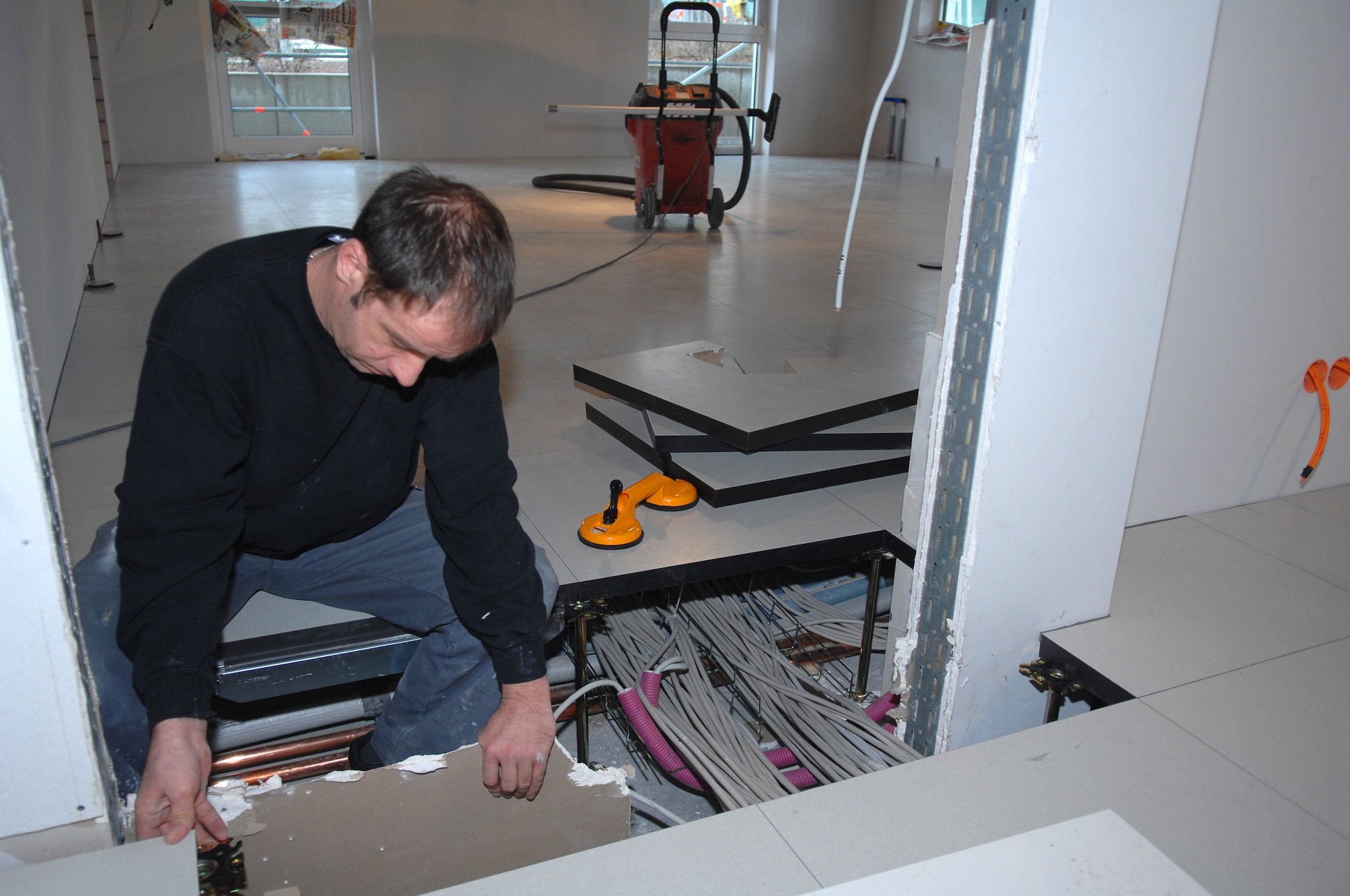 A German contractor works on electrical wiring in Building 301A, the building is currently under final phases of construction at Ramstein Air Base, Germany will become the workcenter for the 15 personnel who currently work at the Sembach Area Dental Laboratory, Sembach Annex, Germany. The dental laboratory on Sembach is relocating as the Air Force prepares to turnover control of the Annex to the U.S. Army. (U.S. Air Force photo by Tech. Sgt. Michael Voss)