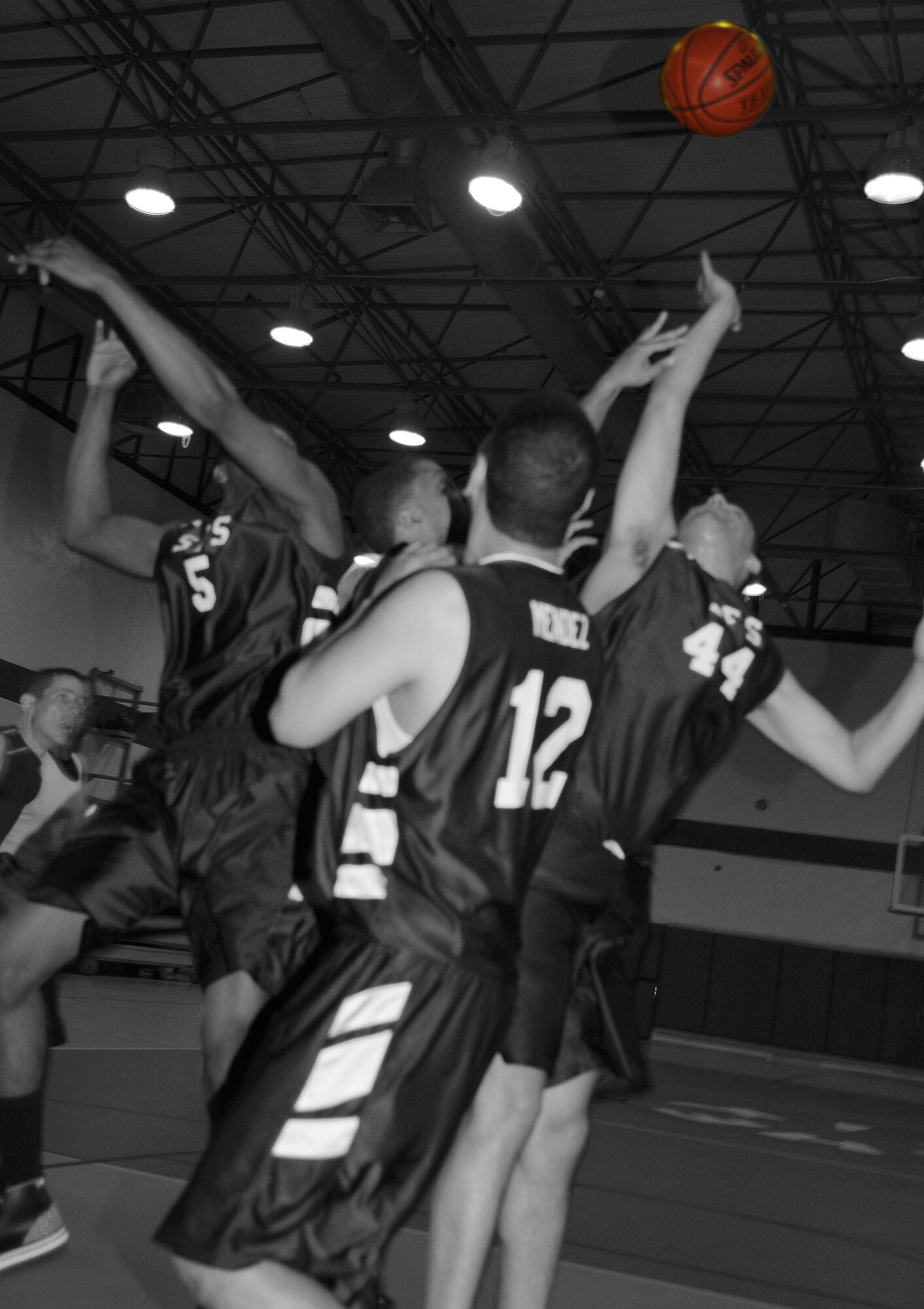 Members of the 39th Security Forces Intramural Basketball team jump for a loose basketball during an intramural basketball game Monday, Feb. 22 at Incirlik Air Base, Turkey. The 39th SFS team squeaked by the 39th LRS team 54-53 in the championship game Feb. 23. (U.S. Air Force photo illustration/Senior Airman Alex Martinez)