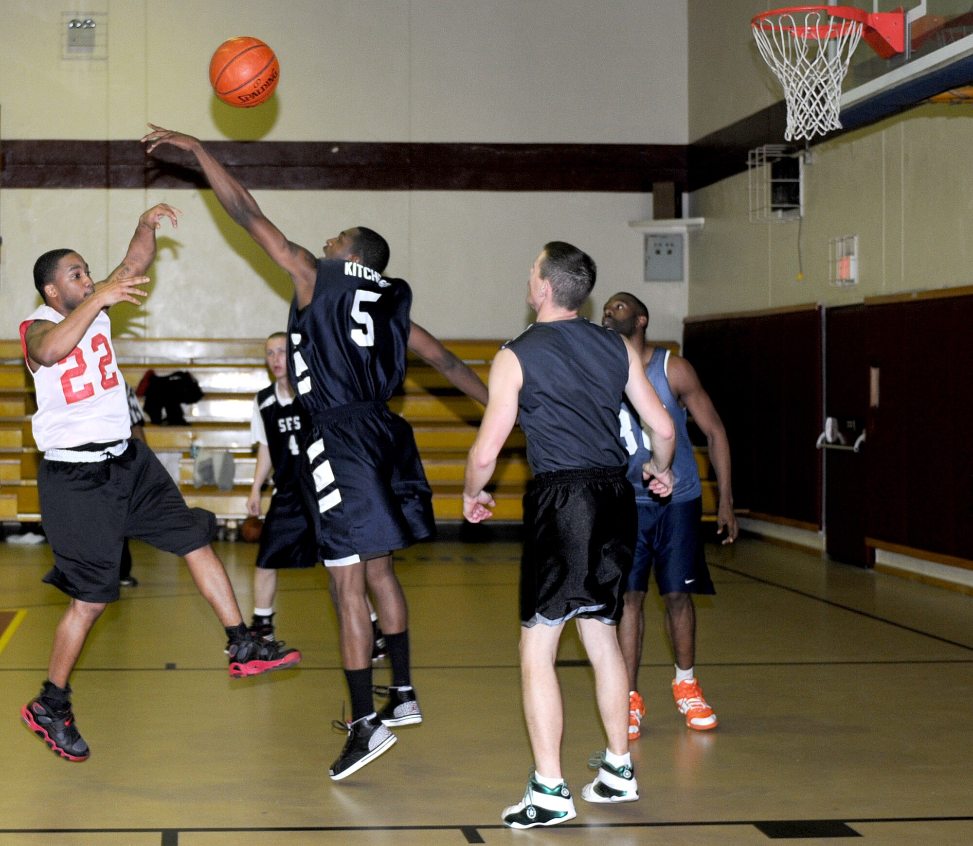 Airman 1st Class Kasey Kitchens, 39th Security Forces Squadron, blocks the shot of Staff Sgt. Maurice Walker, 39th Logistics Readiness Squadron, during an intramural basketball game Monday, Feb. 22 at Incirlik Air Base, Turkey. The 39th SFS team squeaked by the 39th LRS team 54-53 in the championship game Feb. 23. (U.S. Air Force photo/Senior Airman Alex Martinez)