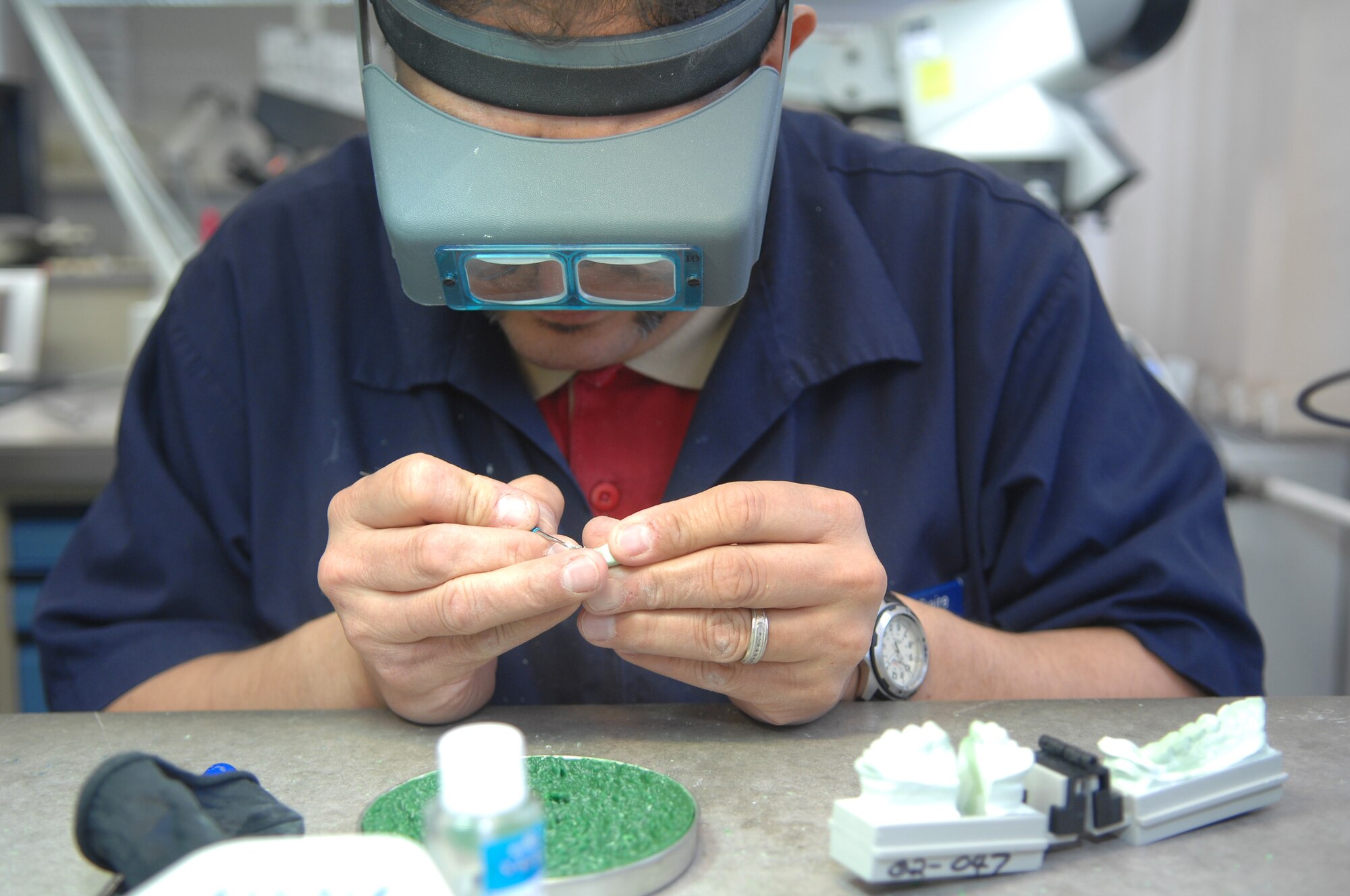 George Fraire a dental prosthetic technician and Colorado Springs native works on a crown-molding at the Sembach Area Dental Laboratory, Sembach Annex, Germany. The Sembach ADL, one of three dental laboratories in the Air Force, will relocate to a new facility Building 301A behind the dental clinic located on Ramstein Air Base, Germany mid April. (U.S. Air Force photo by Tech. Sgt. Michael Voss)