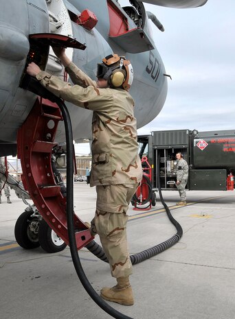 NELLIS AIR FORCE BASE, Nev. -- Petty Officer 3rd Class Richard Vanschaik, Electronic Attack Squadron 209, Andrews AFB, Washington, D.C., conducts refueling operations on an EA-6B Prowler during a preflight at Red Flag, the Air Force's premier aerial combat exercise, Feb. 24. The Prowler is a long-range, all-weather aircraft with advanced electronic countermeasures capability. (U.S. Air Force photo by Tech. Sgt. Chris Flahive)