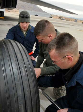 NELLIS AIR FORCE BASE, Nev. -- Maintainers from the 7th Aircraft Maintenance Squadron, Dyess AFB, Texas, change the nose landing gear tire of a B-1B Lancer during a Red Flag exercise Feb. 24. The exercise is the Air Force's premier combat exercise where aircrews from the U.S. and allied nations train in realistic aerial war scenarios over the Nevada Test and Training Range in southern Nevada. (U.S. Air Force photo by Tech. Sgt. Chris Flahive)
